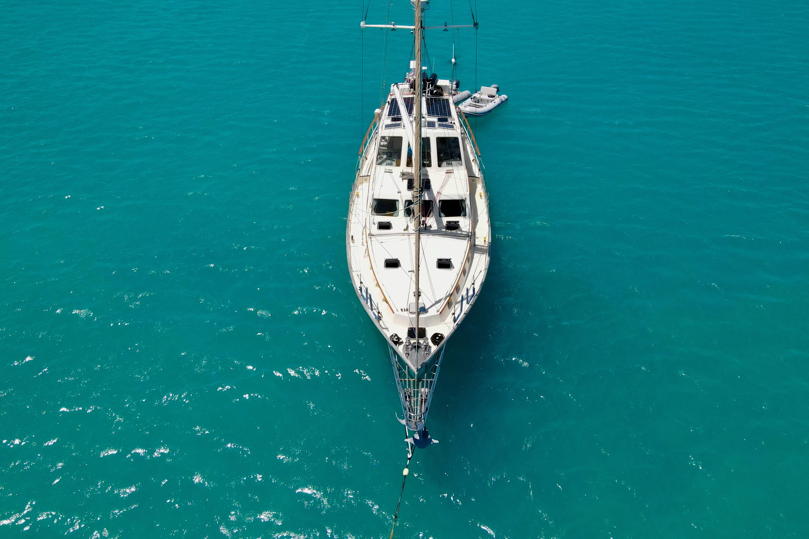 Aerial view of 1995 Benford Custom Pilothouse Cutter on turquoise water.