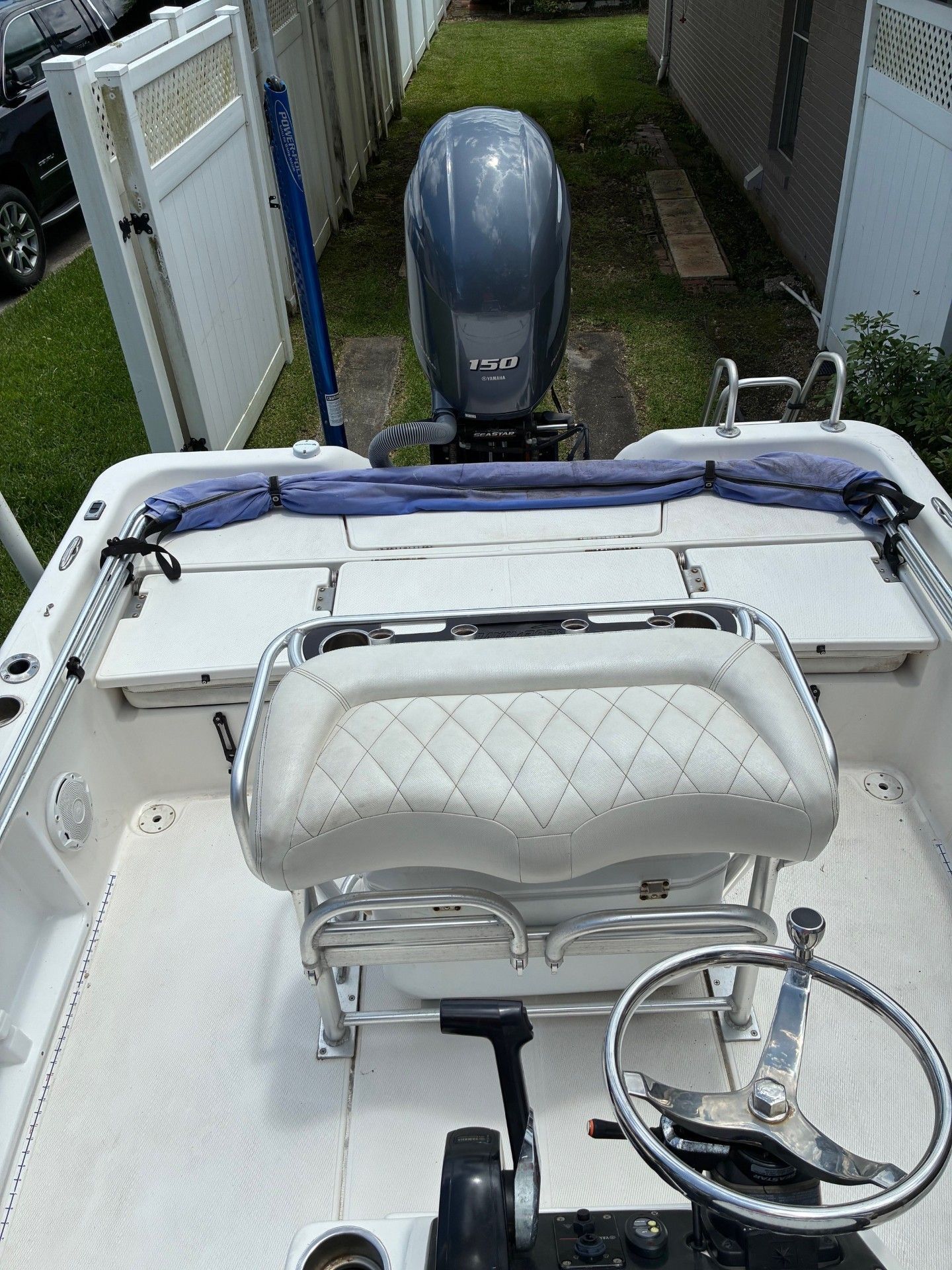 The image shows the cockpit of a 2018 Custom 2200 Pure Bay boat with an outboard motor.