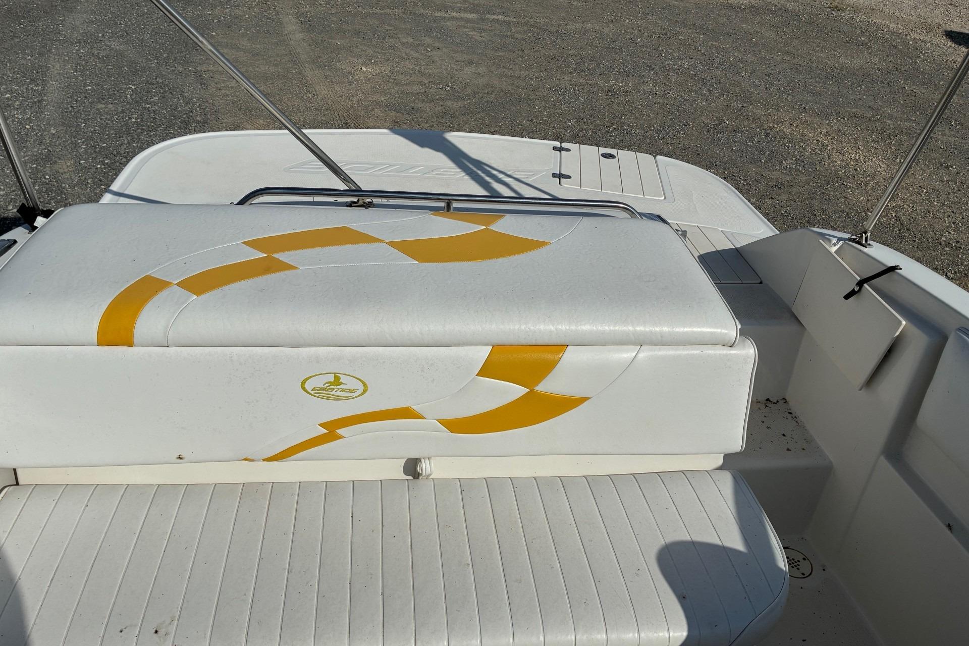 2004 Ebbtide Campione 210 boat interior with yellow design on white seating.