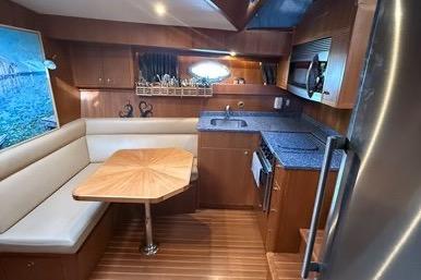 2007 Island Pilot 395 yacht interior with dining area and kitchenette.