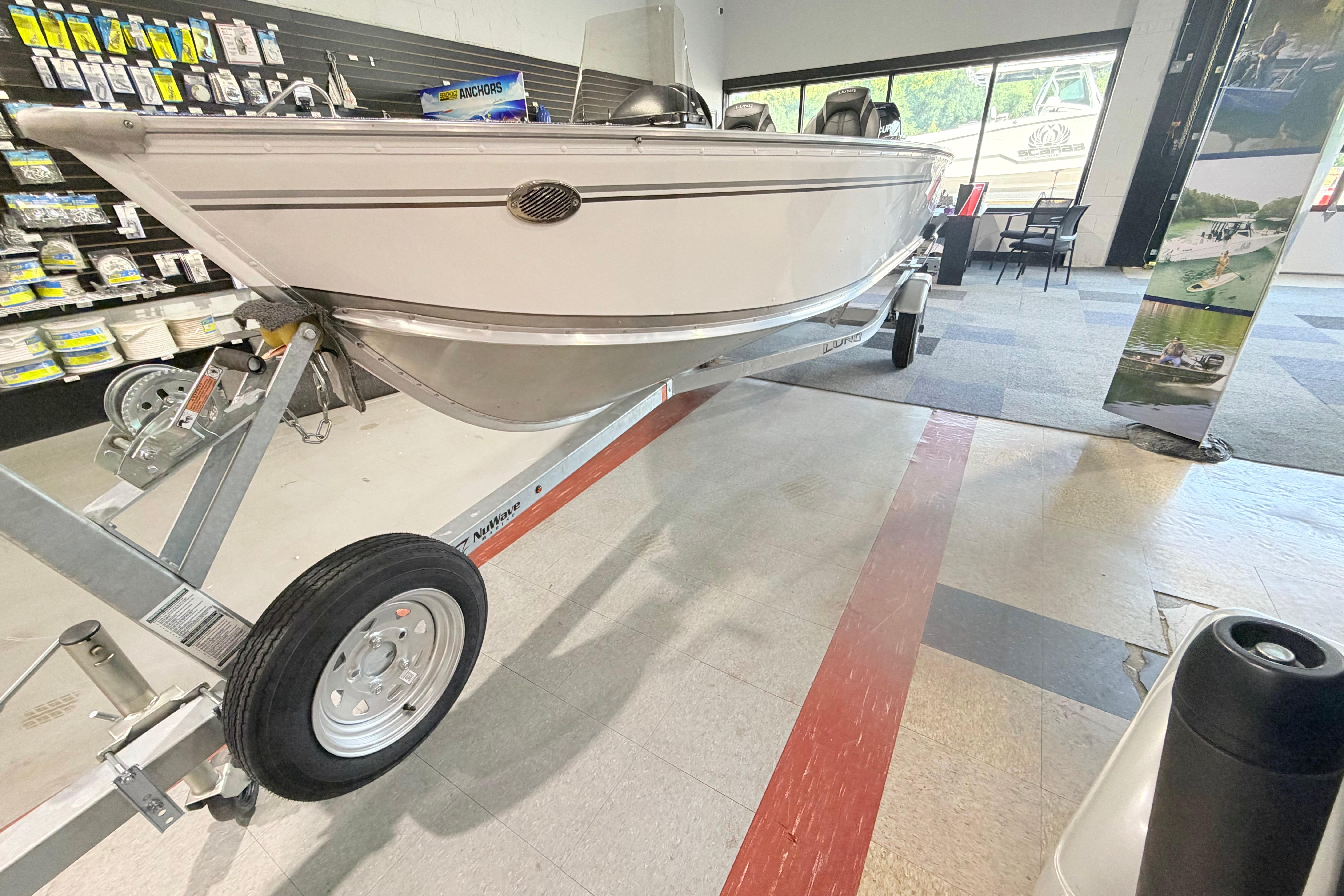 2027 Lund 1600 Fury SS boat displayed indoors on a trailer.