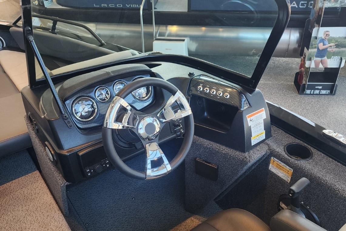 Steering console of a 2023 Lowe boat with modern gauges and controls.