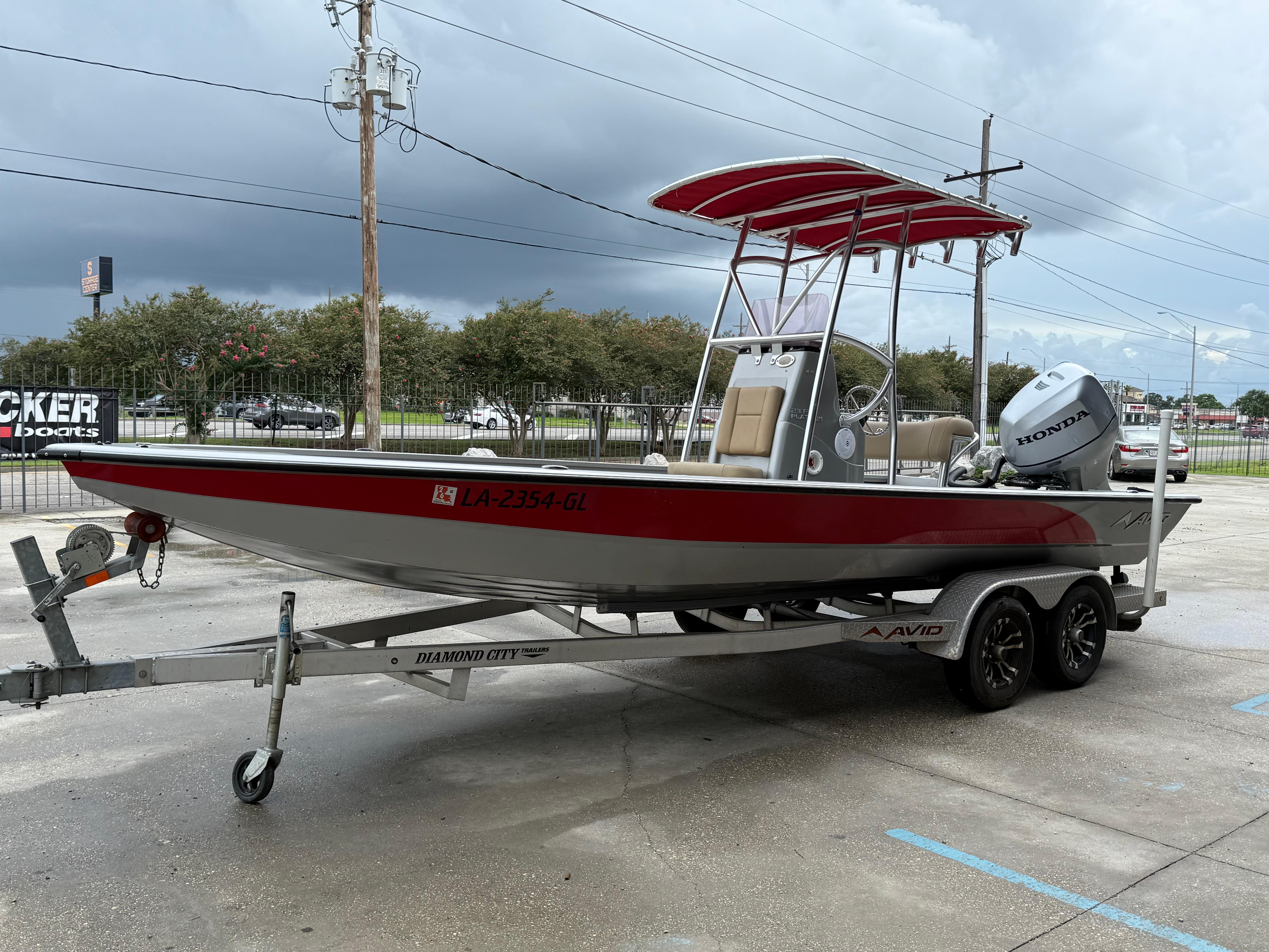 2020 Avid 23 FS Platinum boat on trailer with Honda outboard motor, parked outdoors.