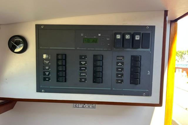 Electrical control panel on a 2006 Morris 36 boat, featuring switches and gauges.