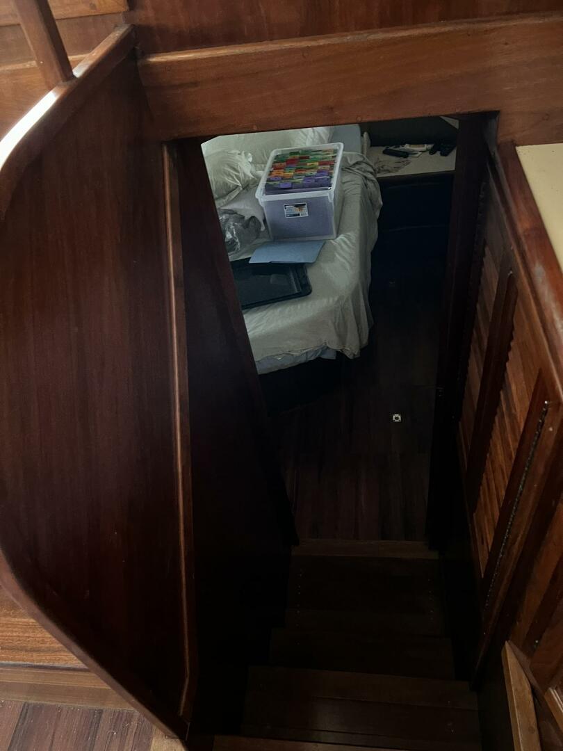 Interior view of 1987 Californian 42 Motor Yacht with wooden stairs and cozy cabin.