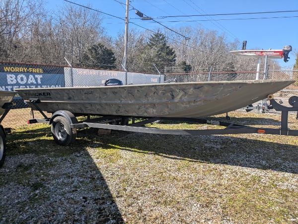 2025 Tracker Grizzly 1754 Jon boat on trailer, outdoors, sunny day.