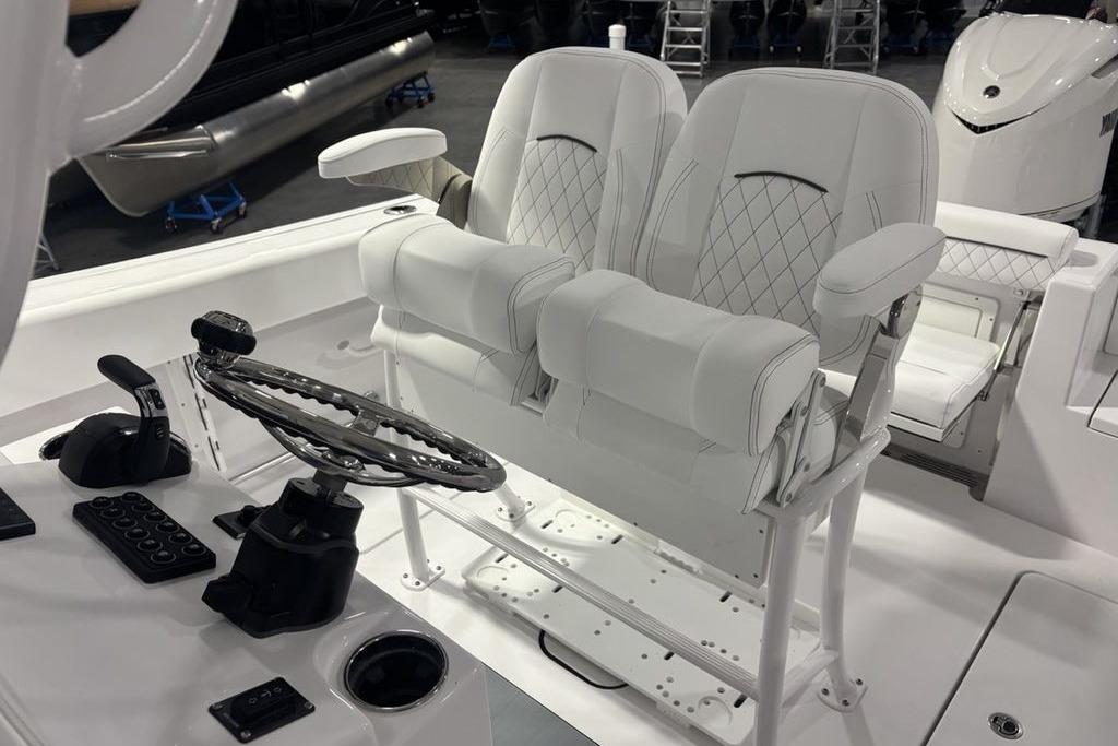 2026 Sportsman Open 252 Center Console helm with dual white cushioned seats.