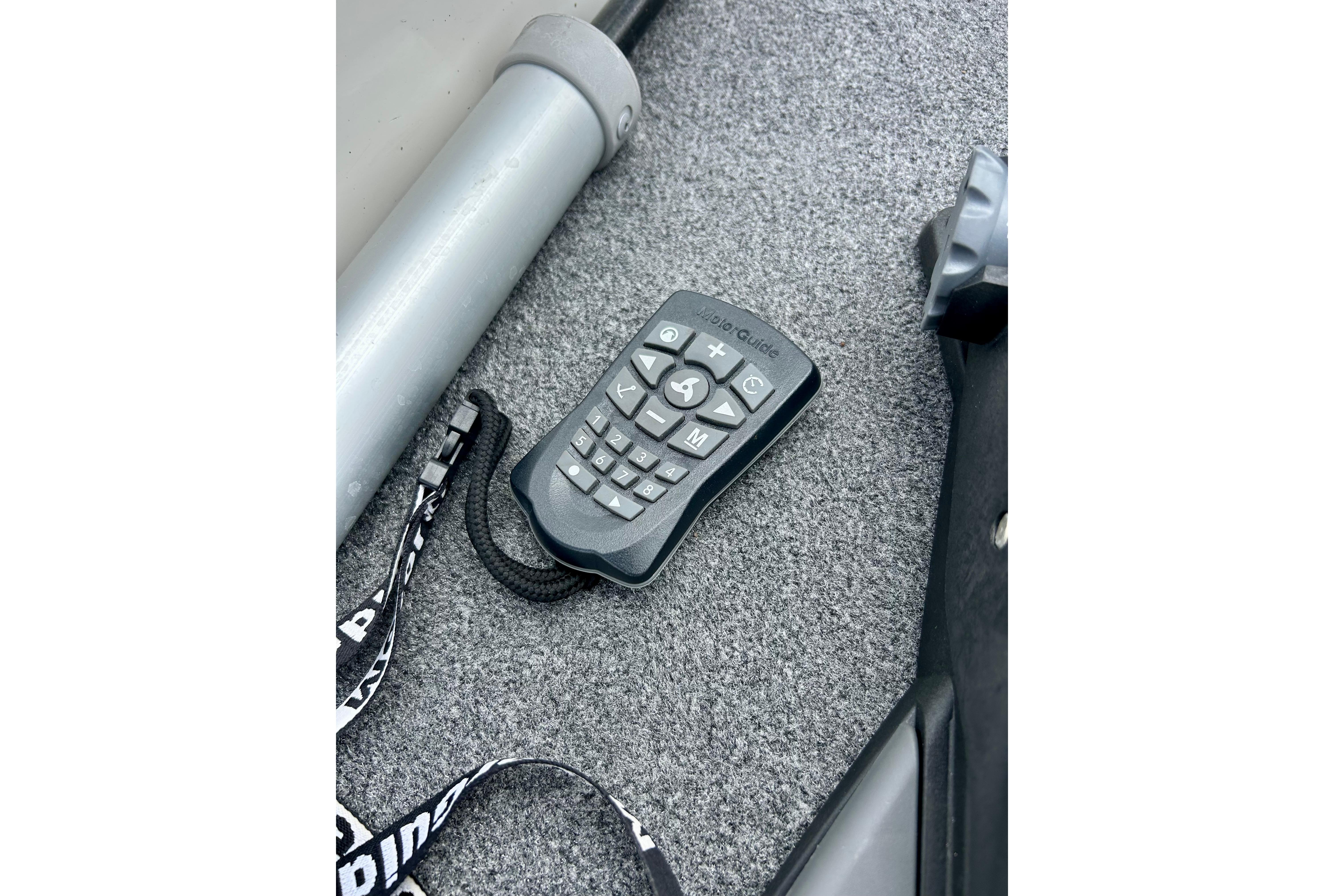 Remote control on carpeted floor of 1994 Stratos 290 Ski-N-Fish boat.
