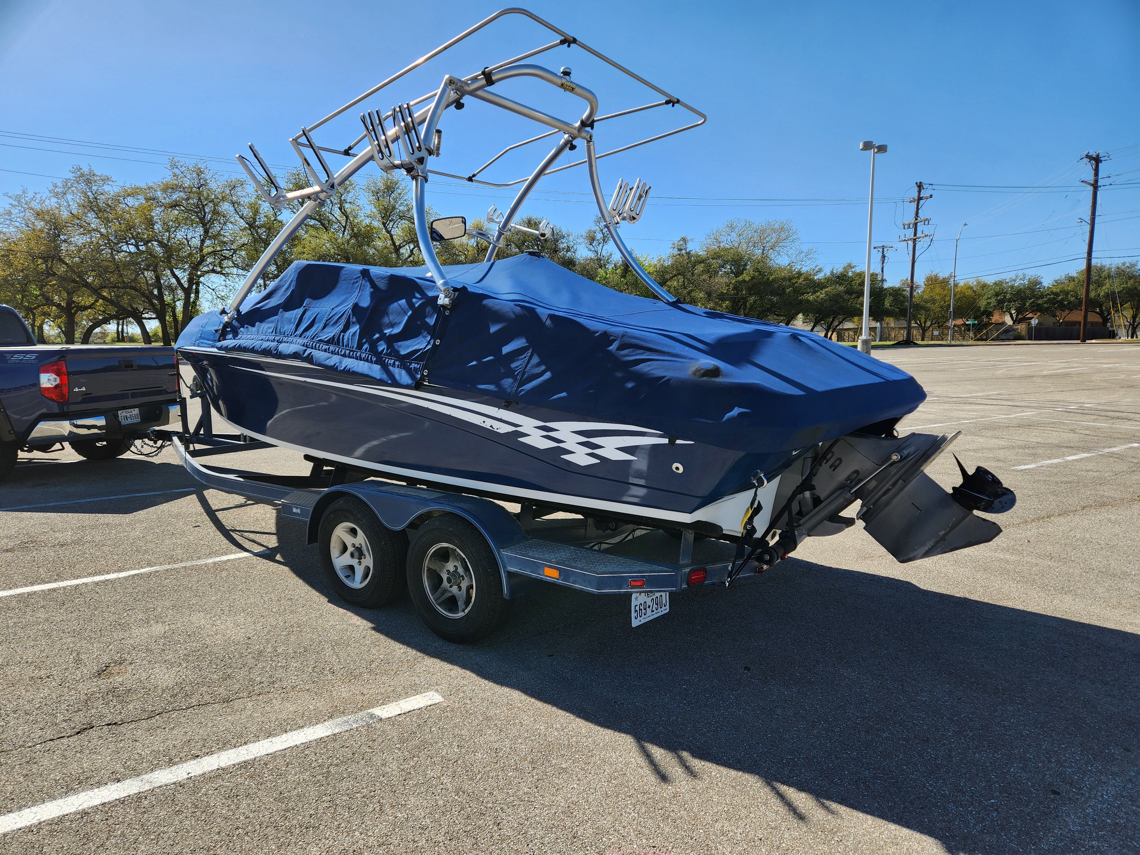 2003 Crownline 225 BR boat on trailer parked outdoors.