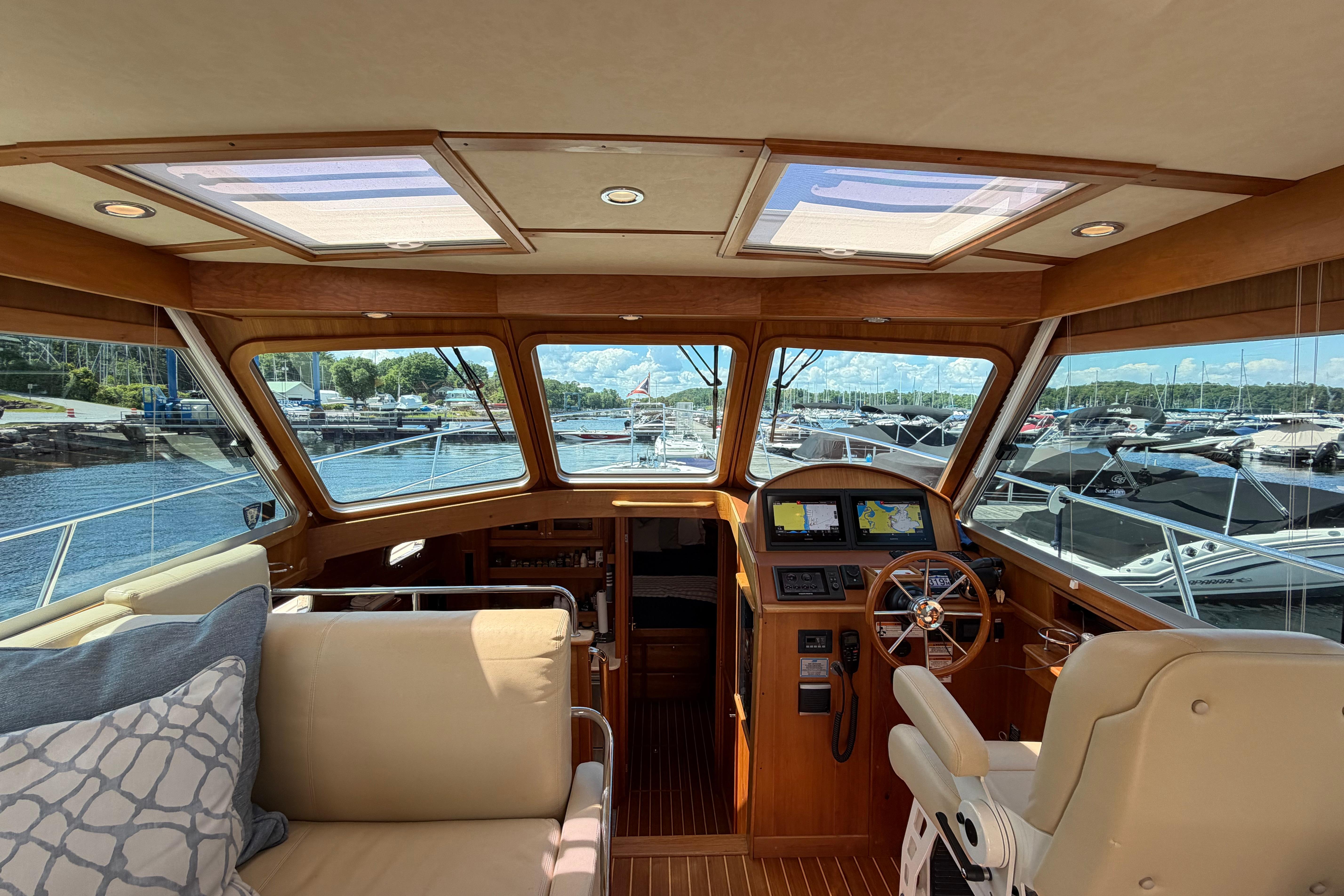 Interior view of 2015 Sabre 38 Salon Express yacht with helm and seating area.