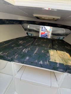 Interior of a 2001 Intrepid 322 Cuddy with cushioned sleeping area.