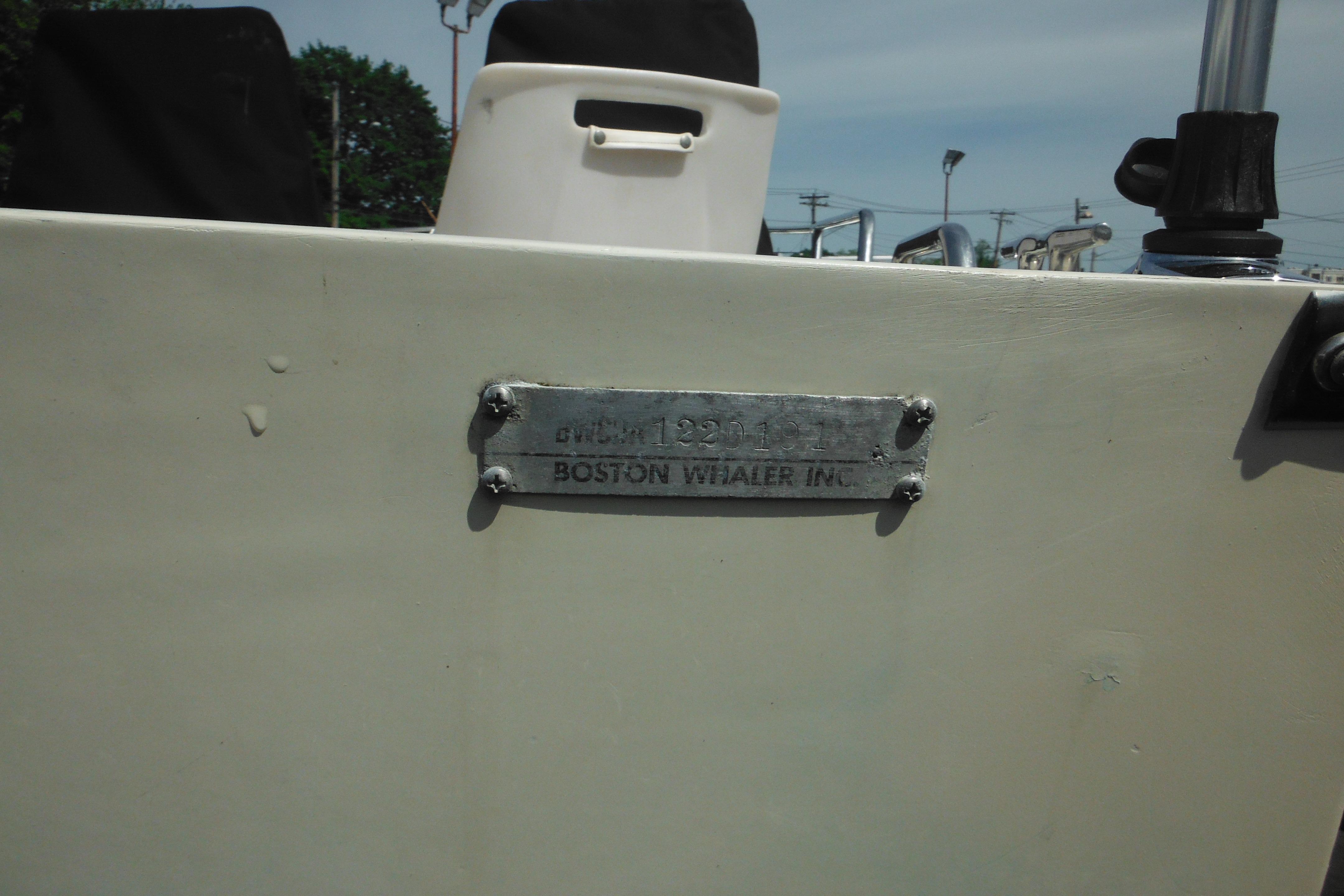 1991 Boston Whaler 16 SL boat with identification plate, outdoor setting.
