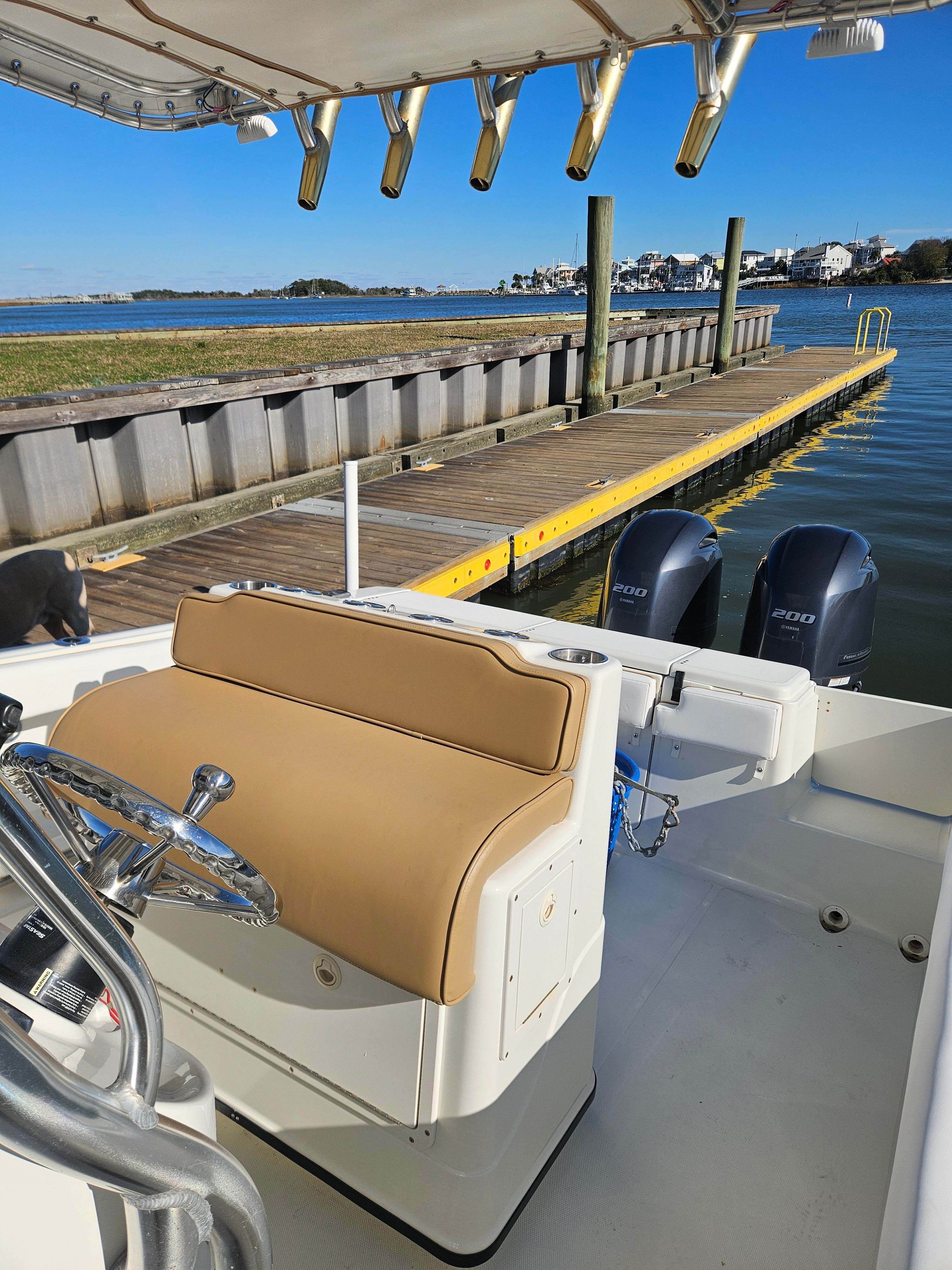 Triton 2690 CC boat docked with dual outboard engines.