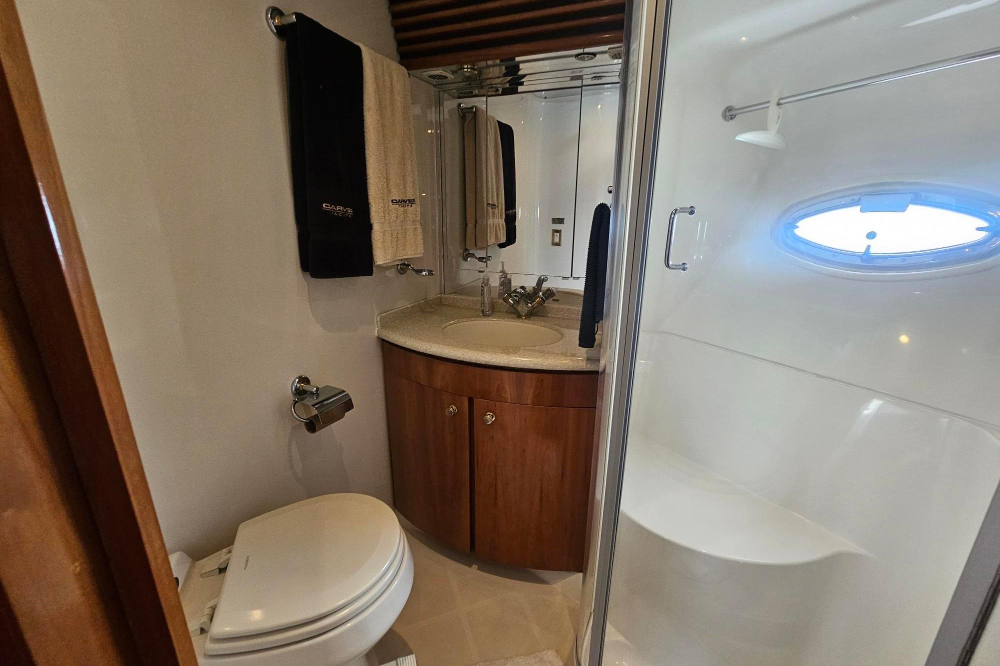 Luxurious bathroom in 2002 Carver 450 Voyager Pilothouse yacht with shower and vanity.