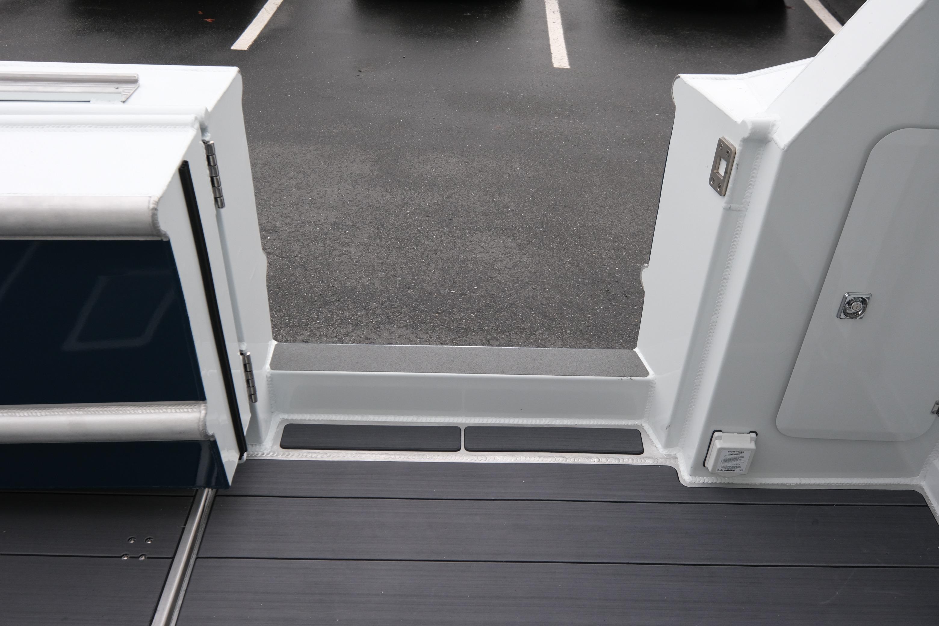 2026 Hewescraft 270 Pacific Explorer boat deck with open door, showcasing sleek design.