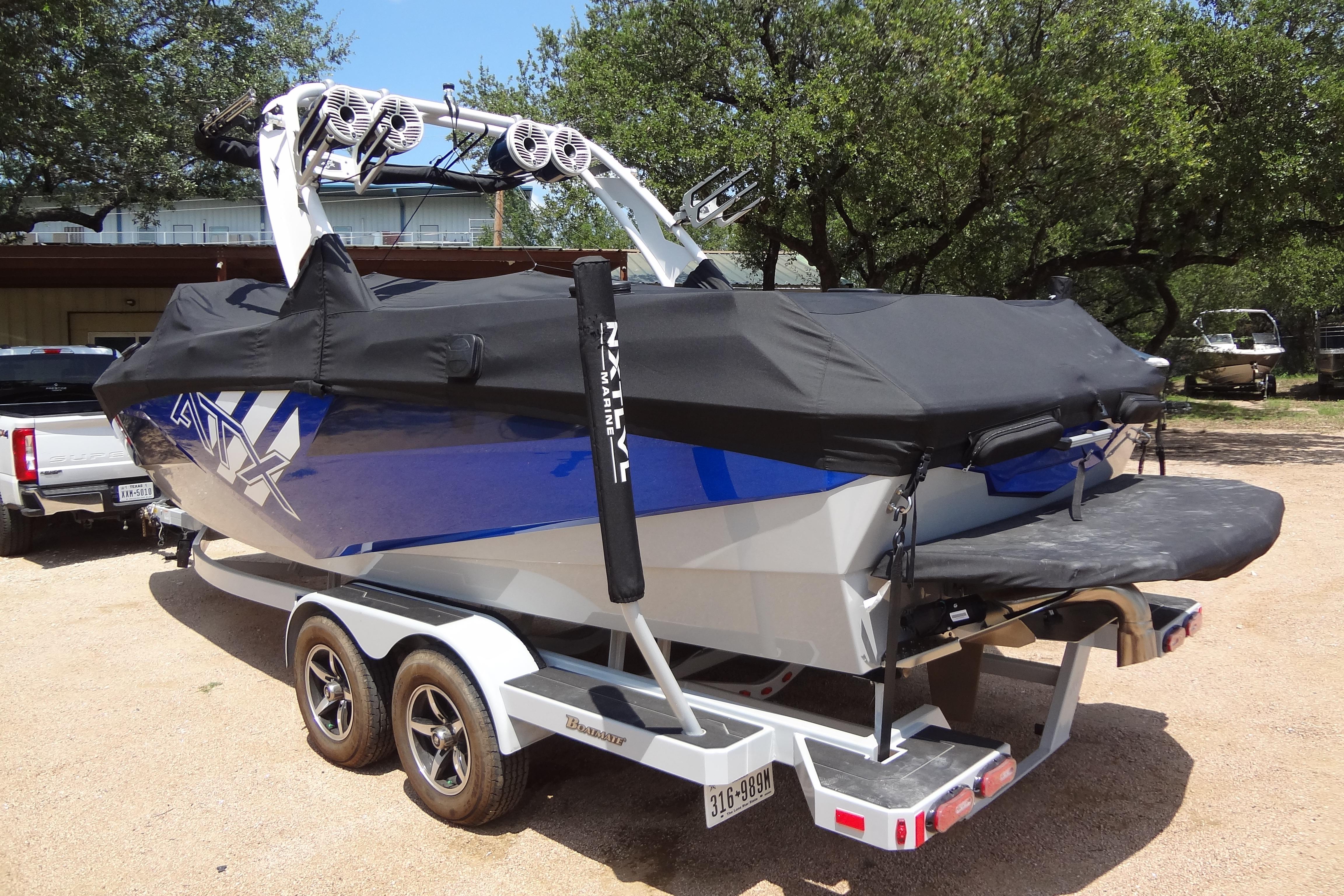 2022 ATX Surf Boats 24 Type-S on trailer, covered, in outdoor setting.
