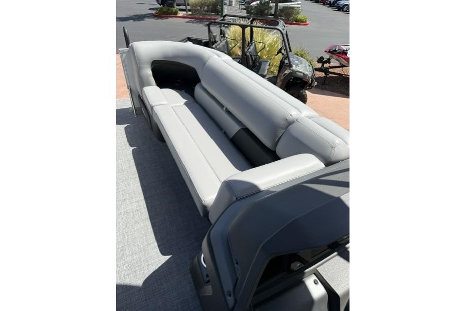 2026 Sun Tracker Party Barge 20 DLX with spacious gray seating on deck.