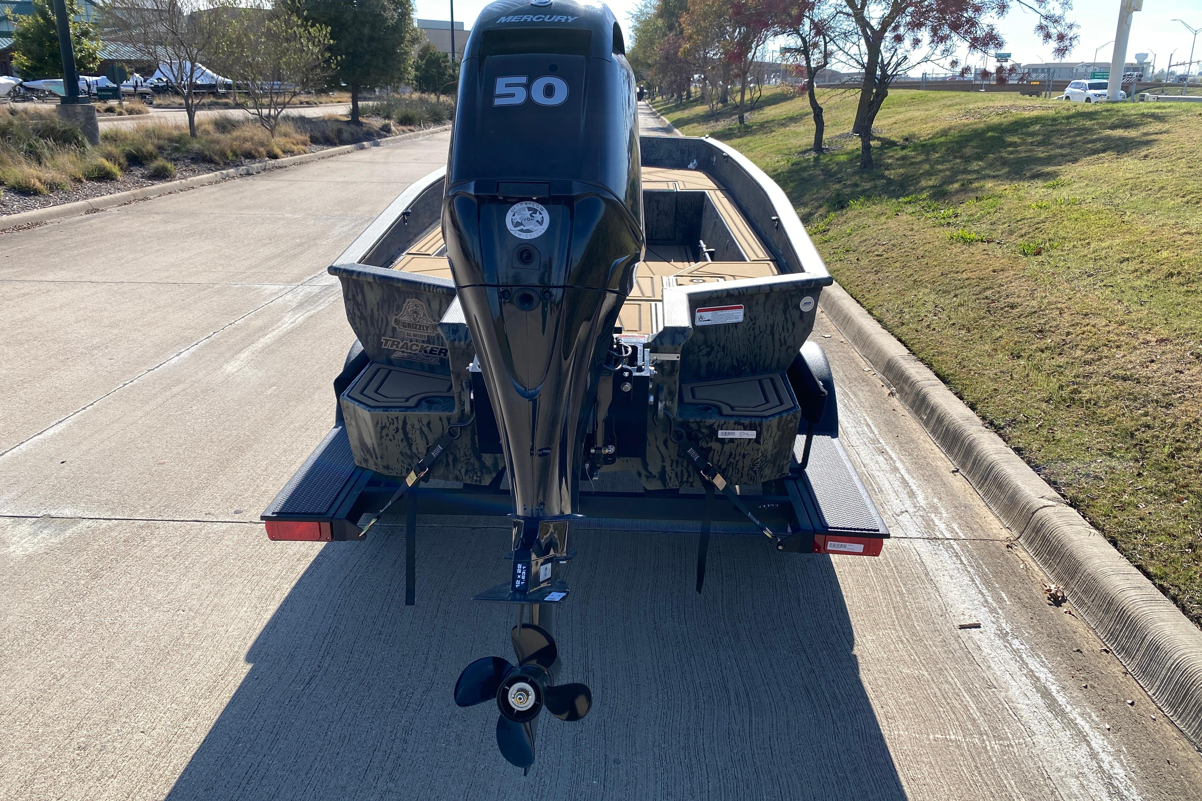 2026 Tracker Grizzly 1650 T Prairie Wings Edition boat on trailer, rear view.