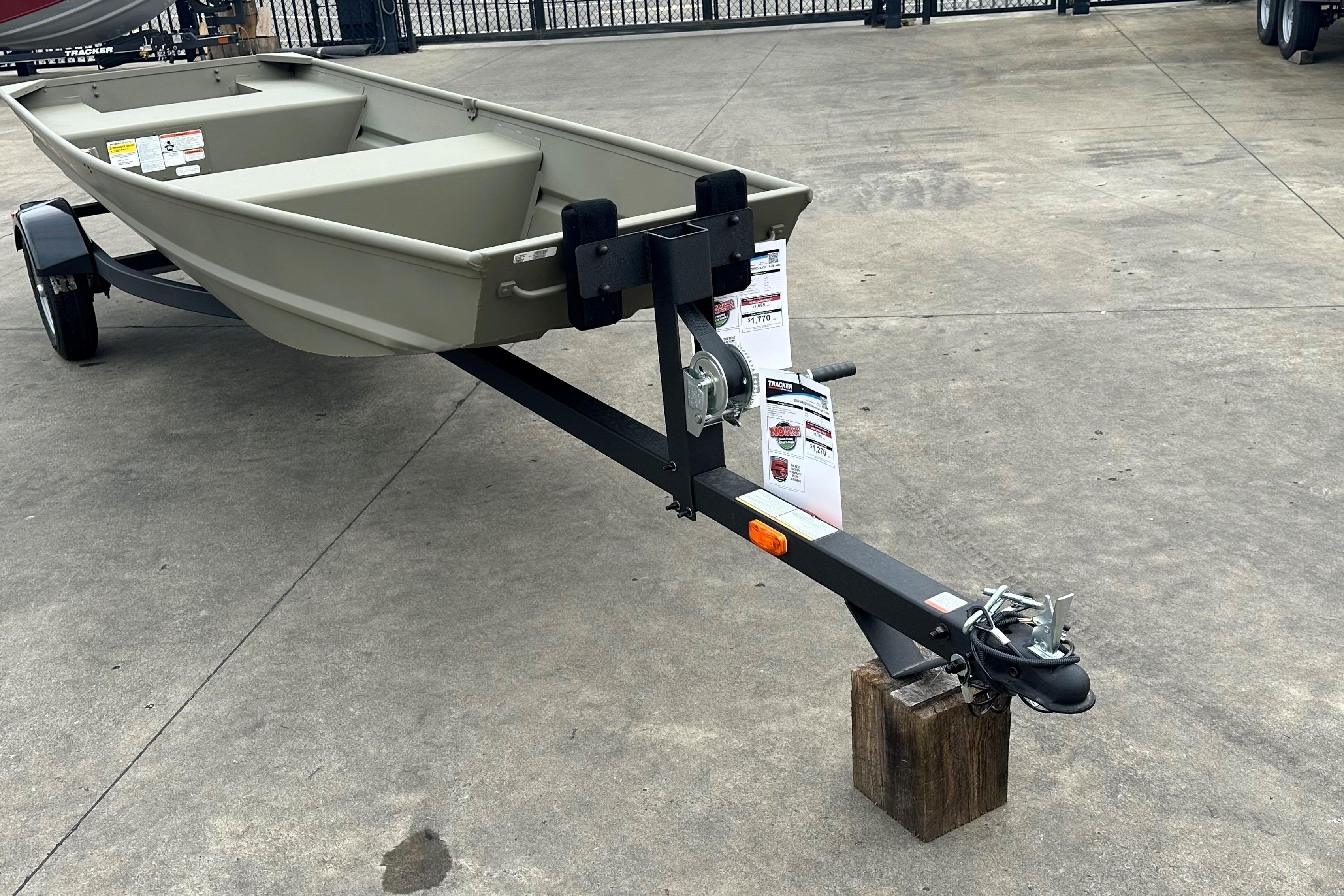 2026 Tracker Grizzly 14 Jon boat on trailer, displayed outdoors on concrete surface.