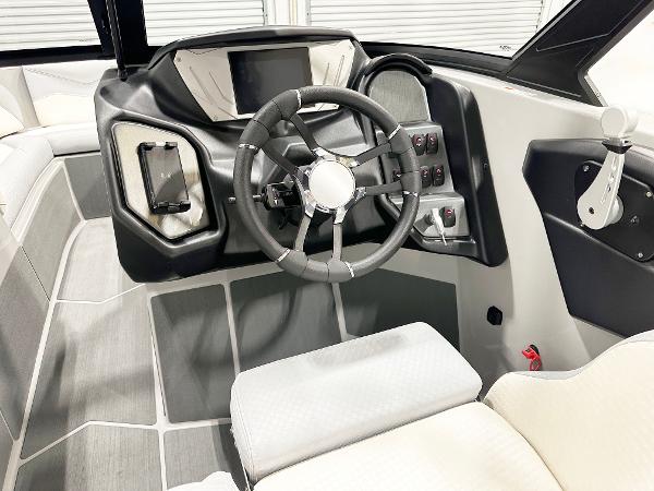 2025 Supreme S240 boat interior with modern steering wheel and control panel.