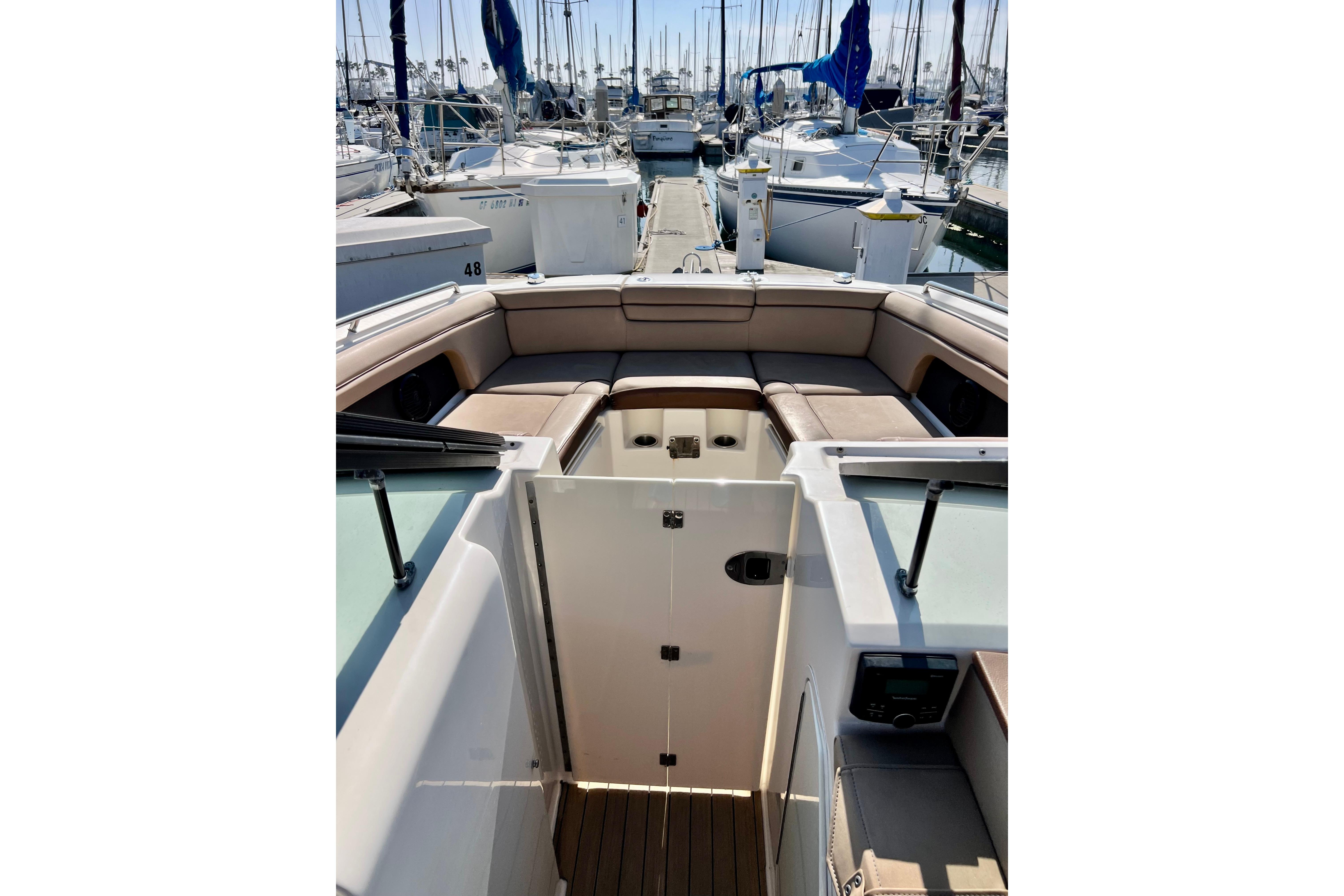 2016 Sea Ray 290 Sundeck Outboard interior with spacious seating at marina.