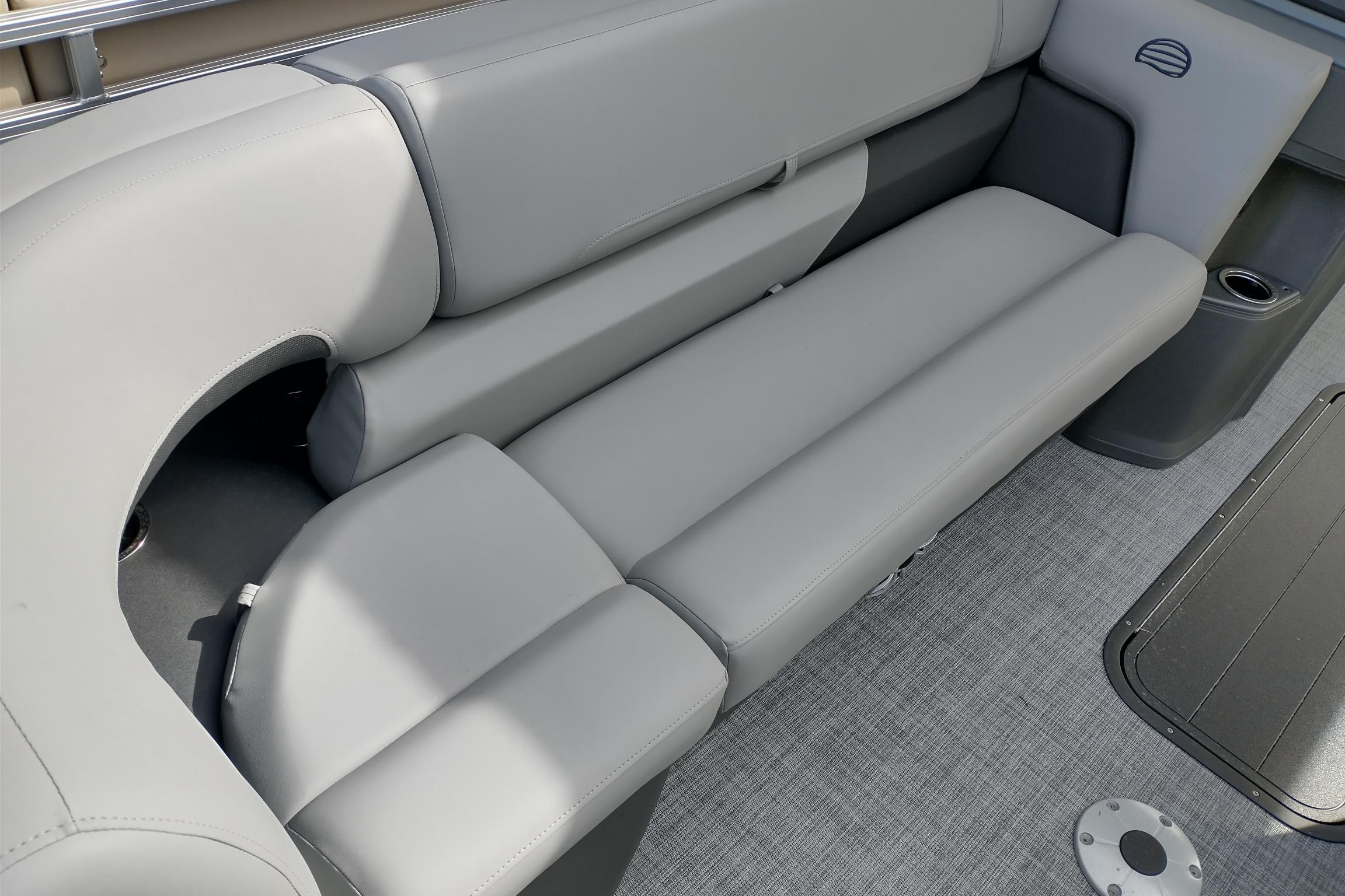 2026 Sun Tracker Party Barge 22 XP3 interior with gray seating and cup holders.