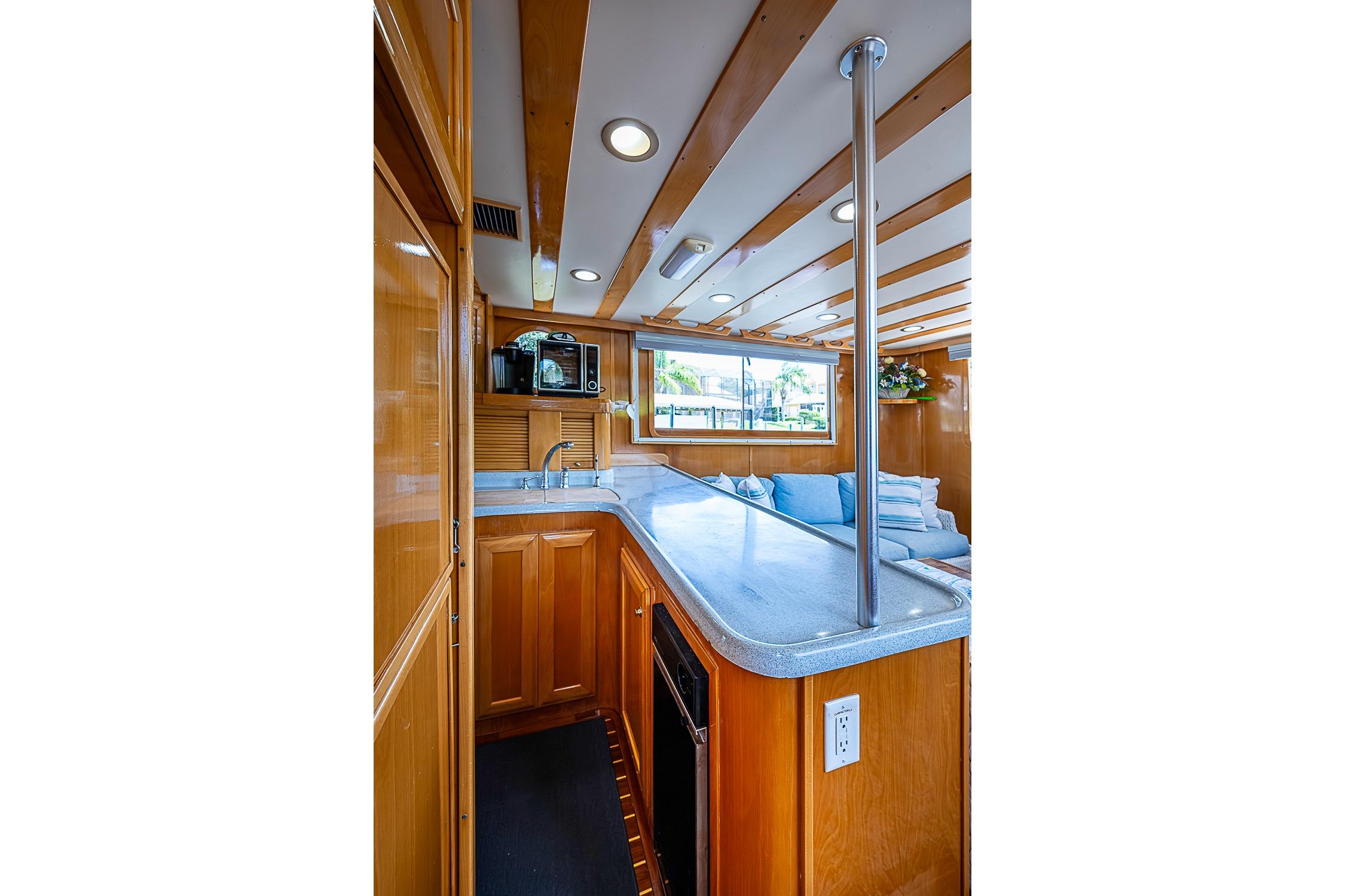 Luxurious 2003 Magna Marine Nova Scotia 47 yacht interior with modern kitchen and seating area.