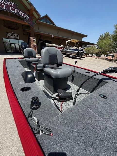 2025 Tracker Panfish 17 boat with seating, displayed at a boat service center.