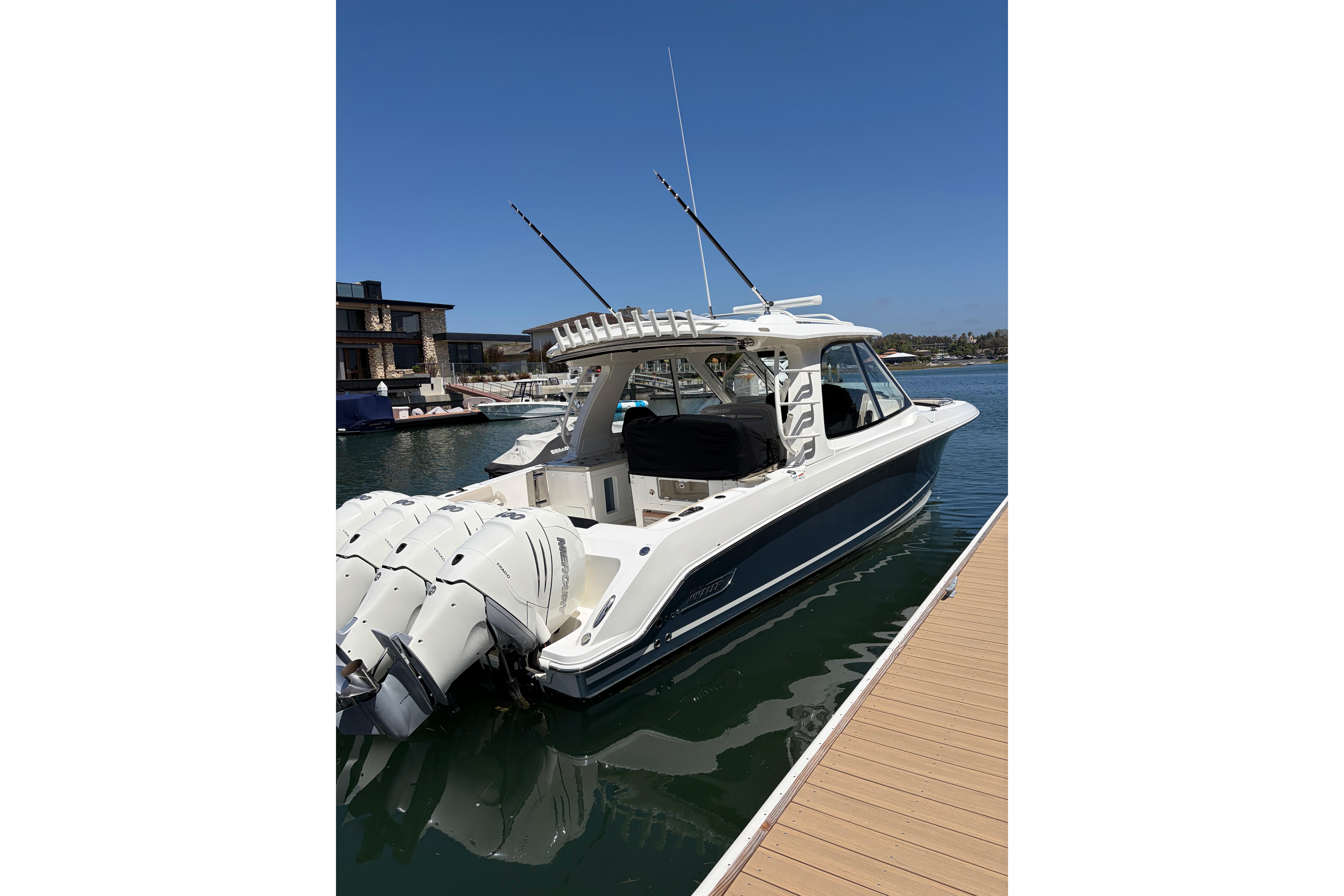 2020 Boston Whaler 380 Realm docked, showcasing sleek design and powerful engines.
