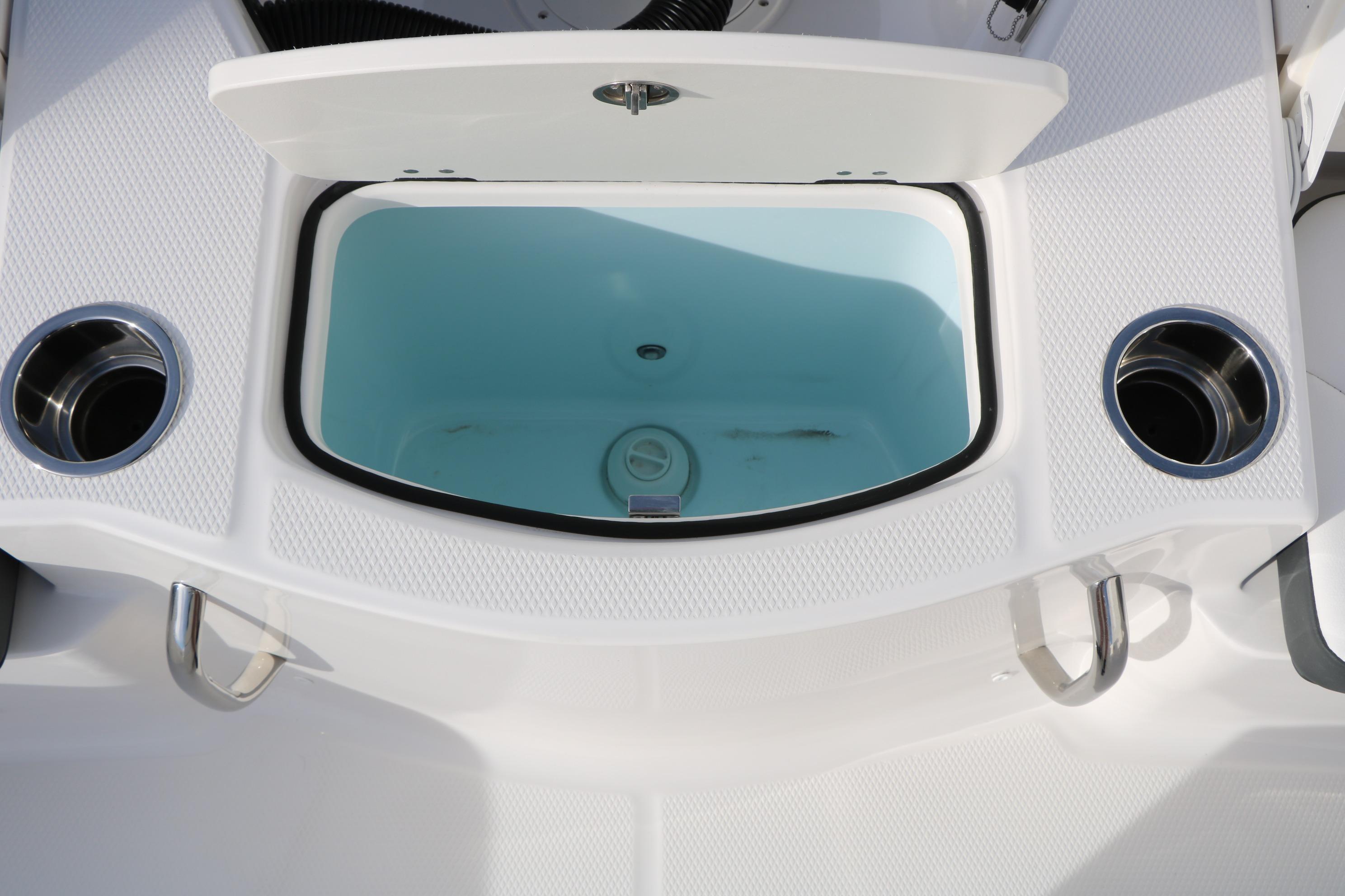 2026 Robalo 206 Cayman boat livewell with open lid and cup holders.