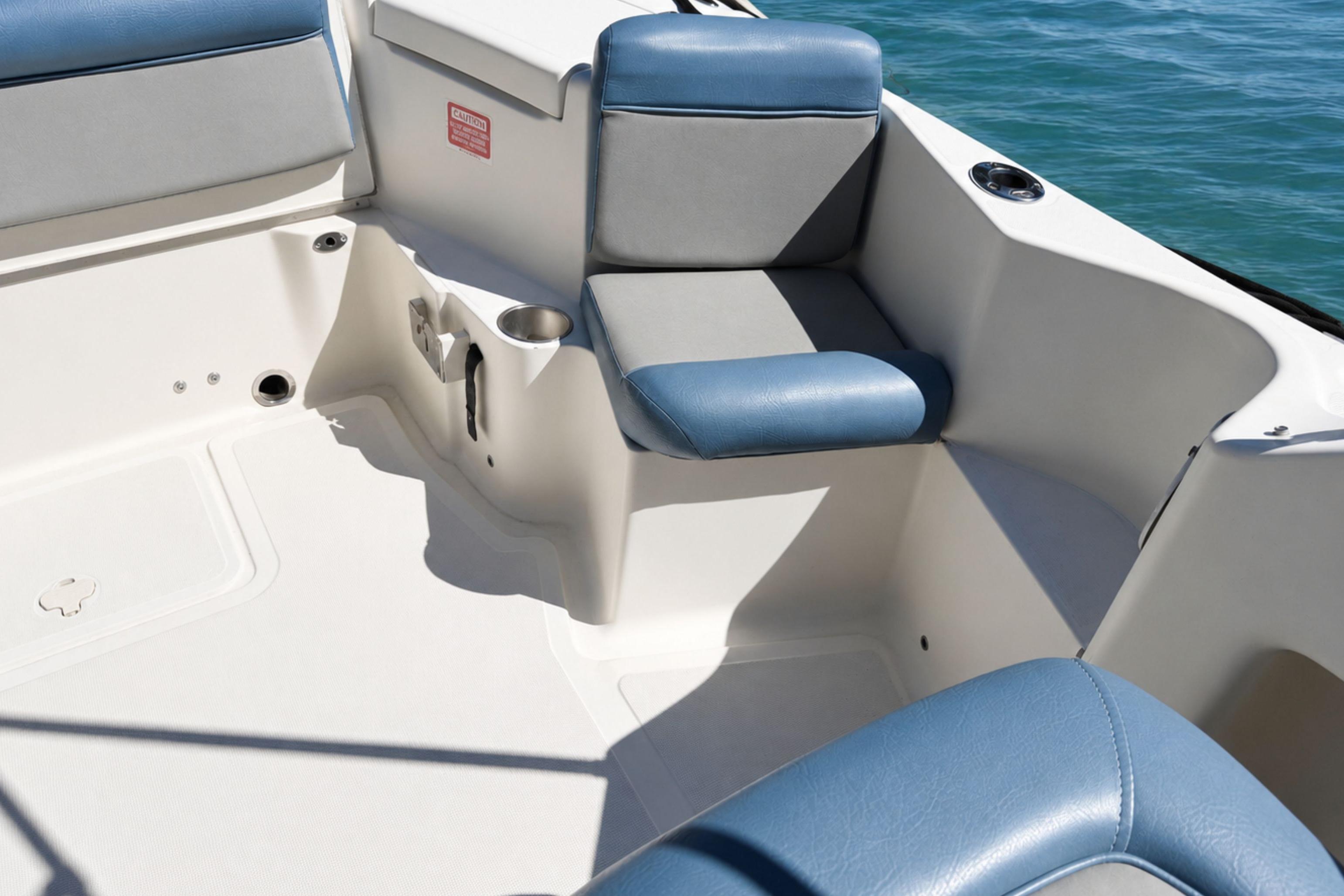 2008 Scout 222 Abaco boat interior with blue and gray seating, cup holder, and ocean view.