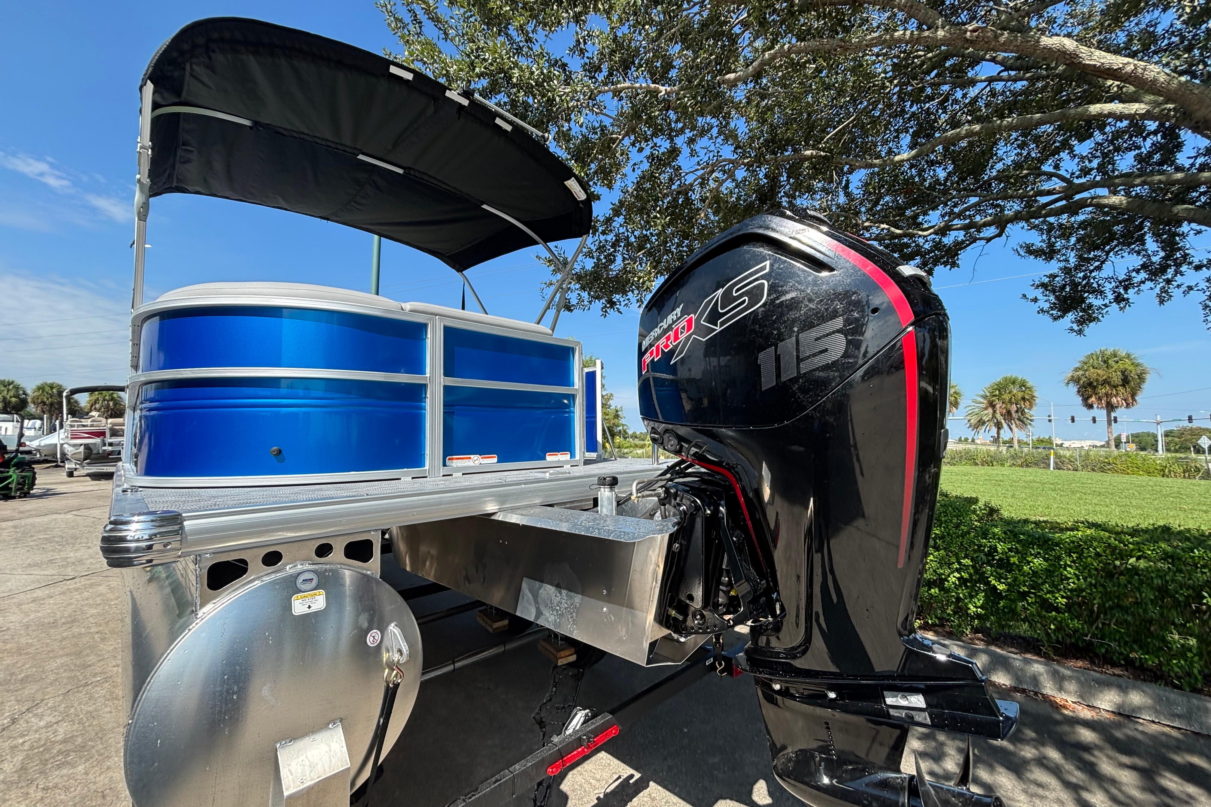 2026 Sun Tracker Party Barge 20 DLX with Mercury Pro XS 115 engine, parked outdoors.