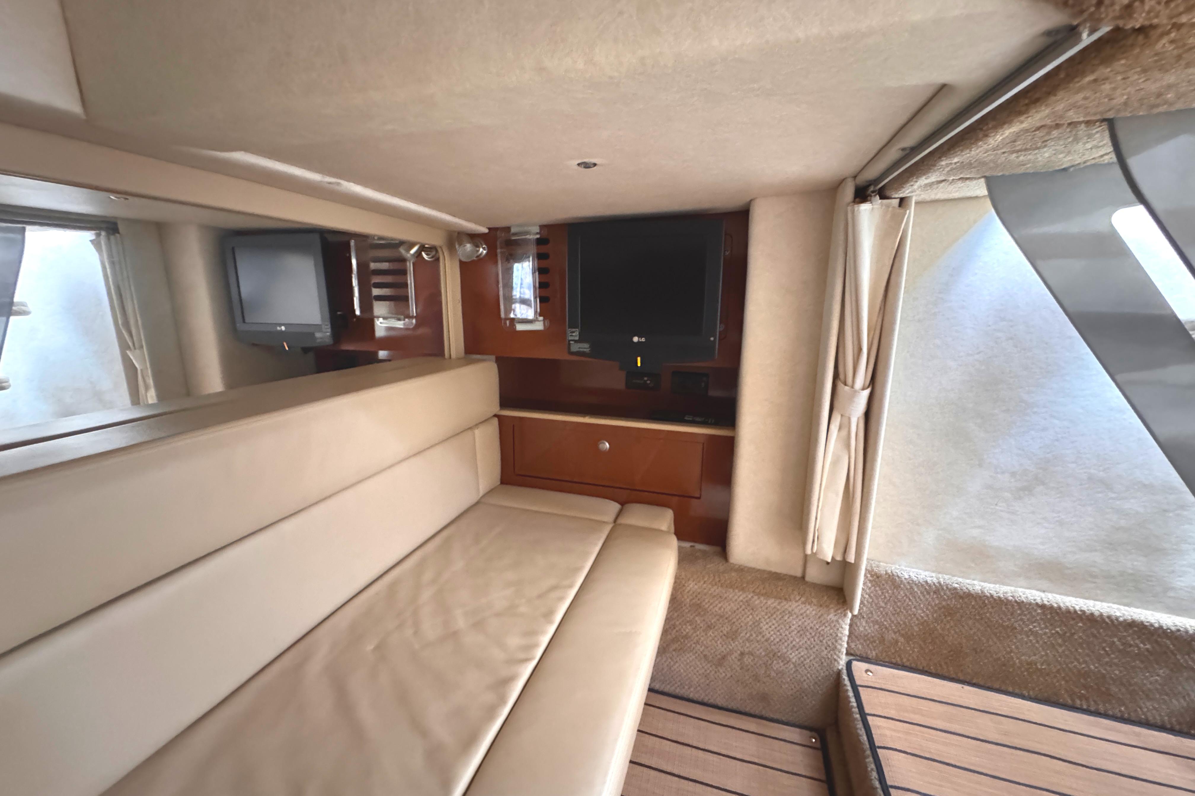 Interior of 2008 Sea Ray Sundancer 350 yacht with beige seating and entertainment area.