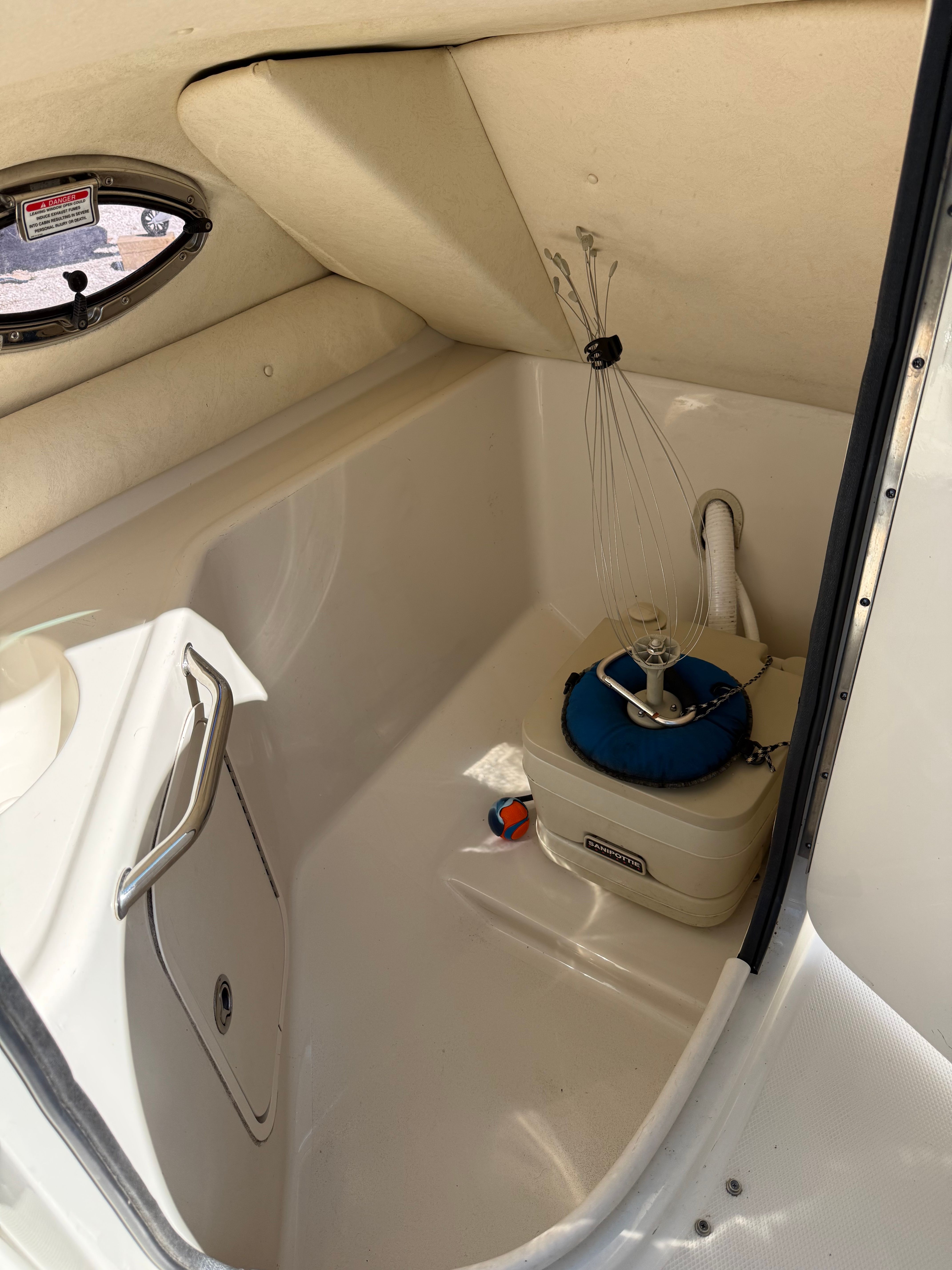Interior of a 2005 Sea Ray 240 Sundeck with storage area.