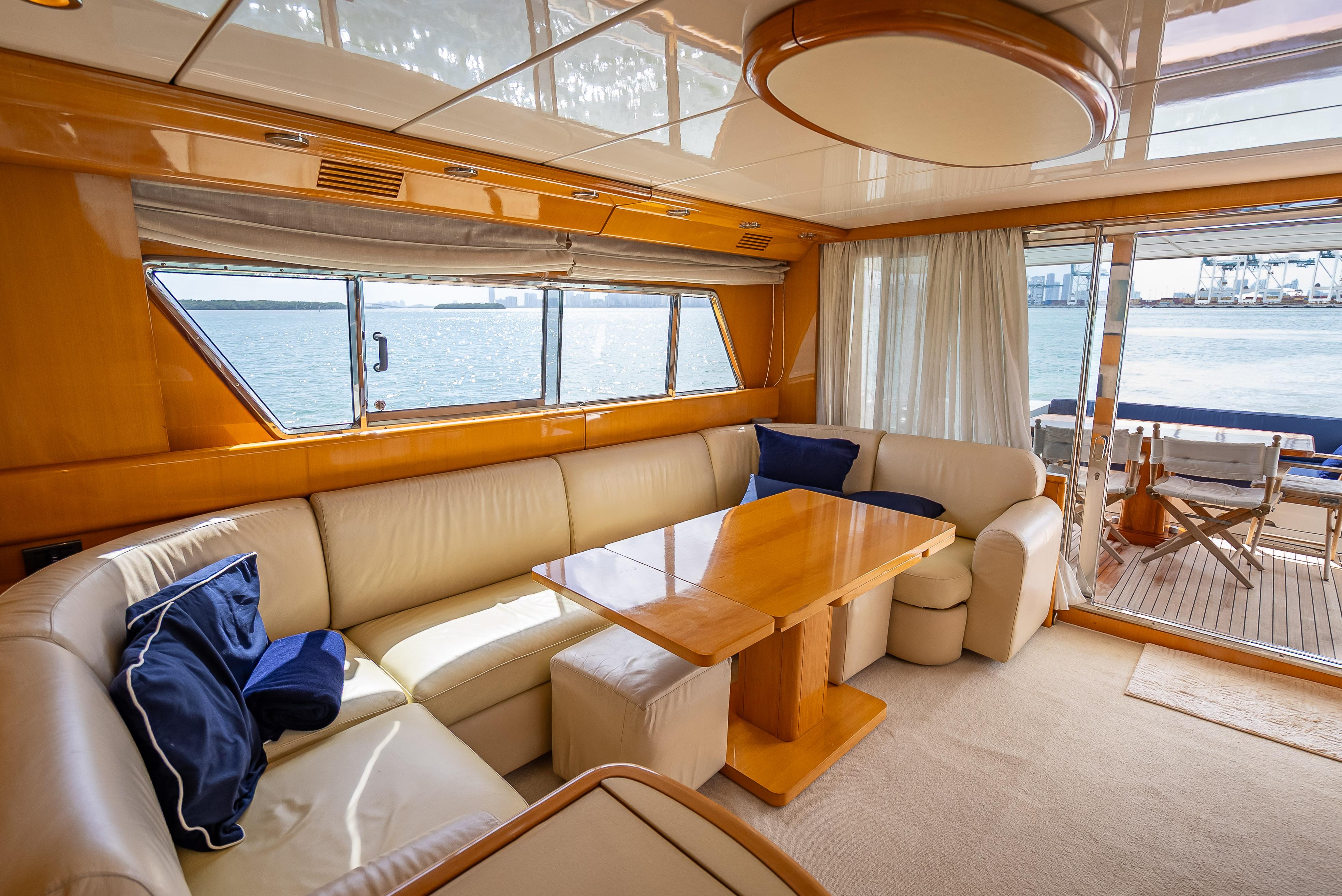 Luxurious interior of a 1995 Sanlorenzo 62 yacht with elegant seating and ocean view.