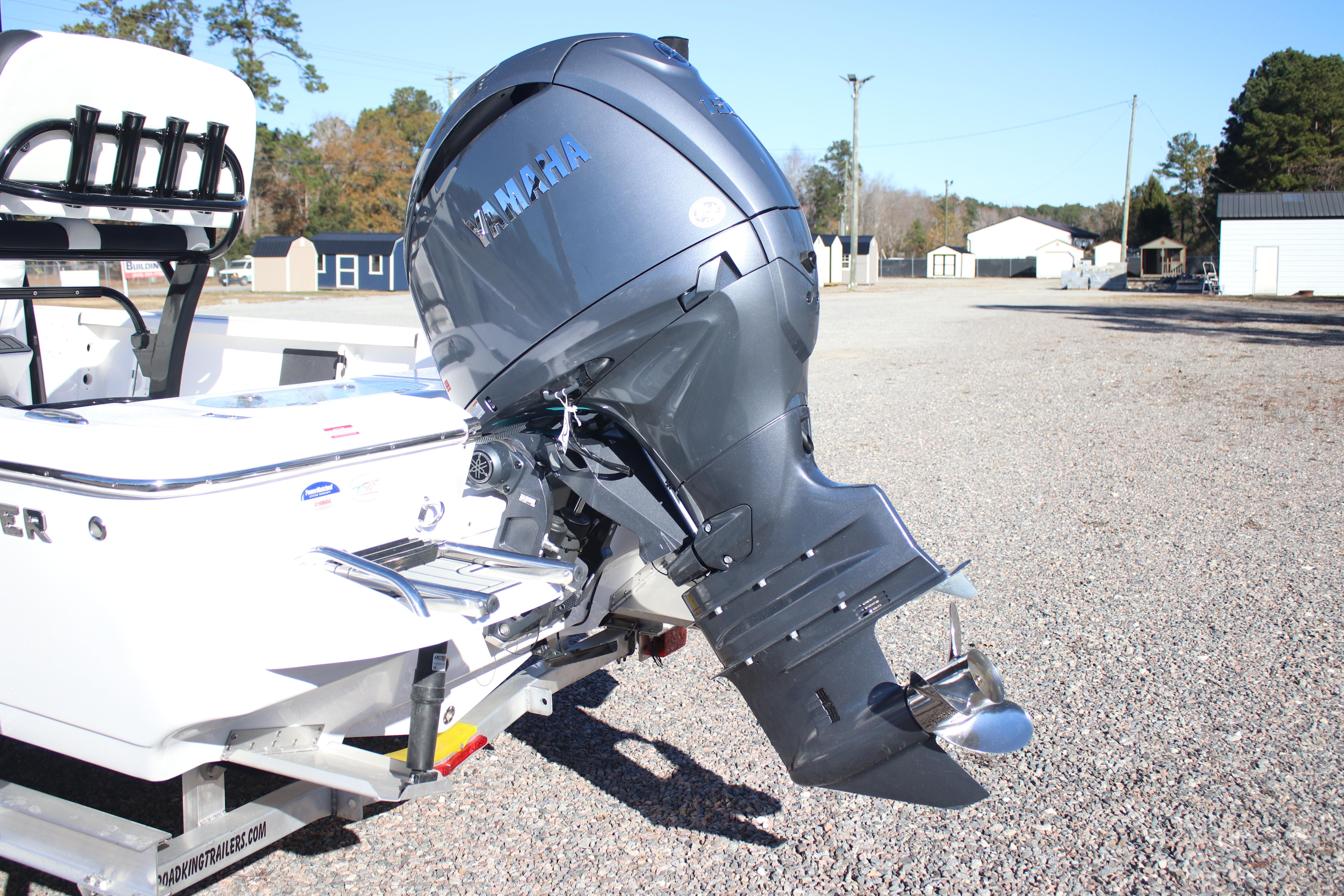 2026 Tidewater 2210 Carolina Bay boat with Yamaha outboard motor on a gravel lot.