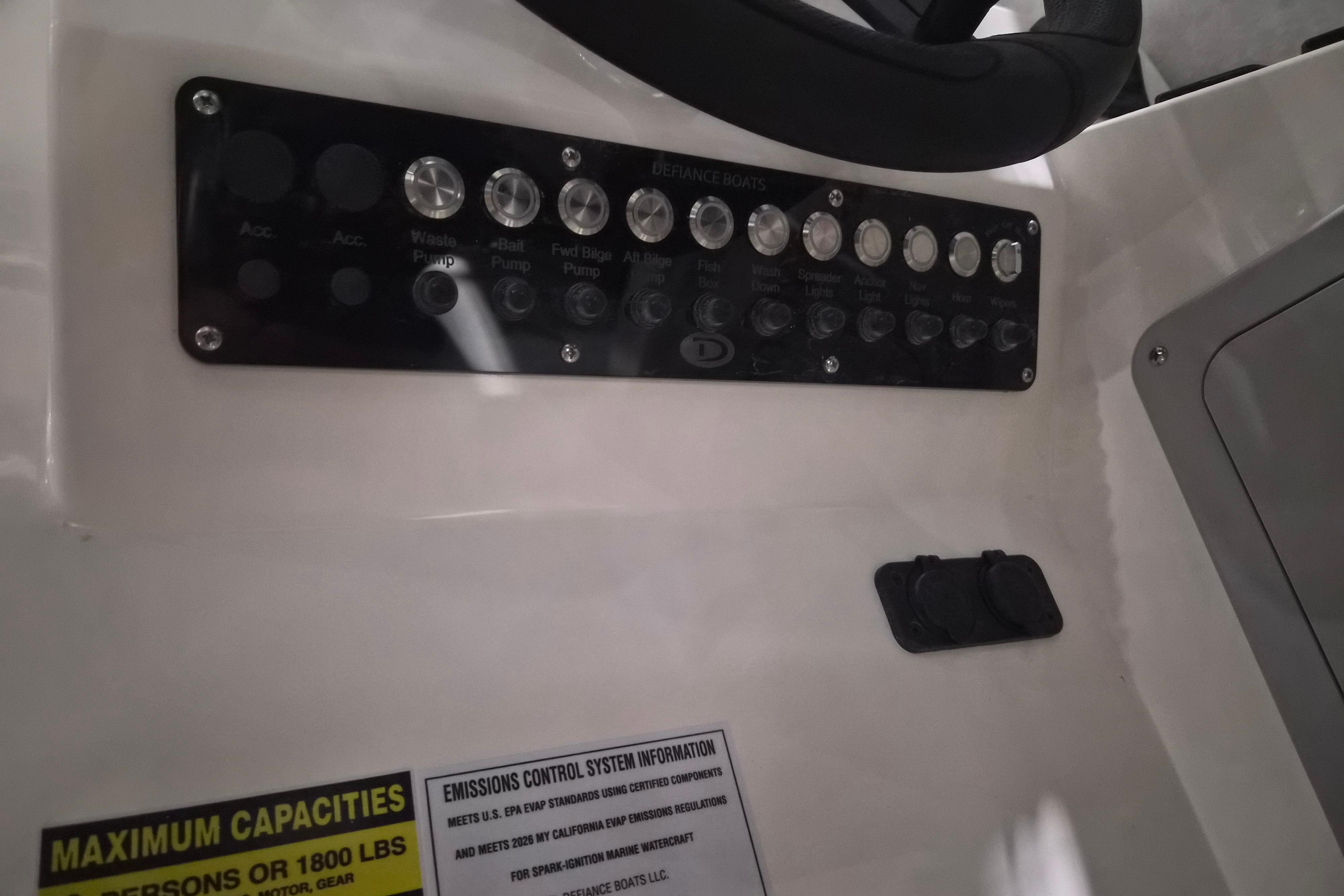Control panel of 2026 Defiance Admiral 260 EX boat with labeled switches and capacity information.