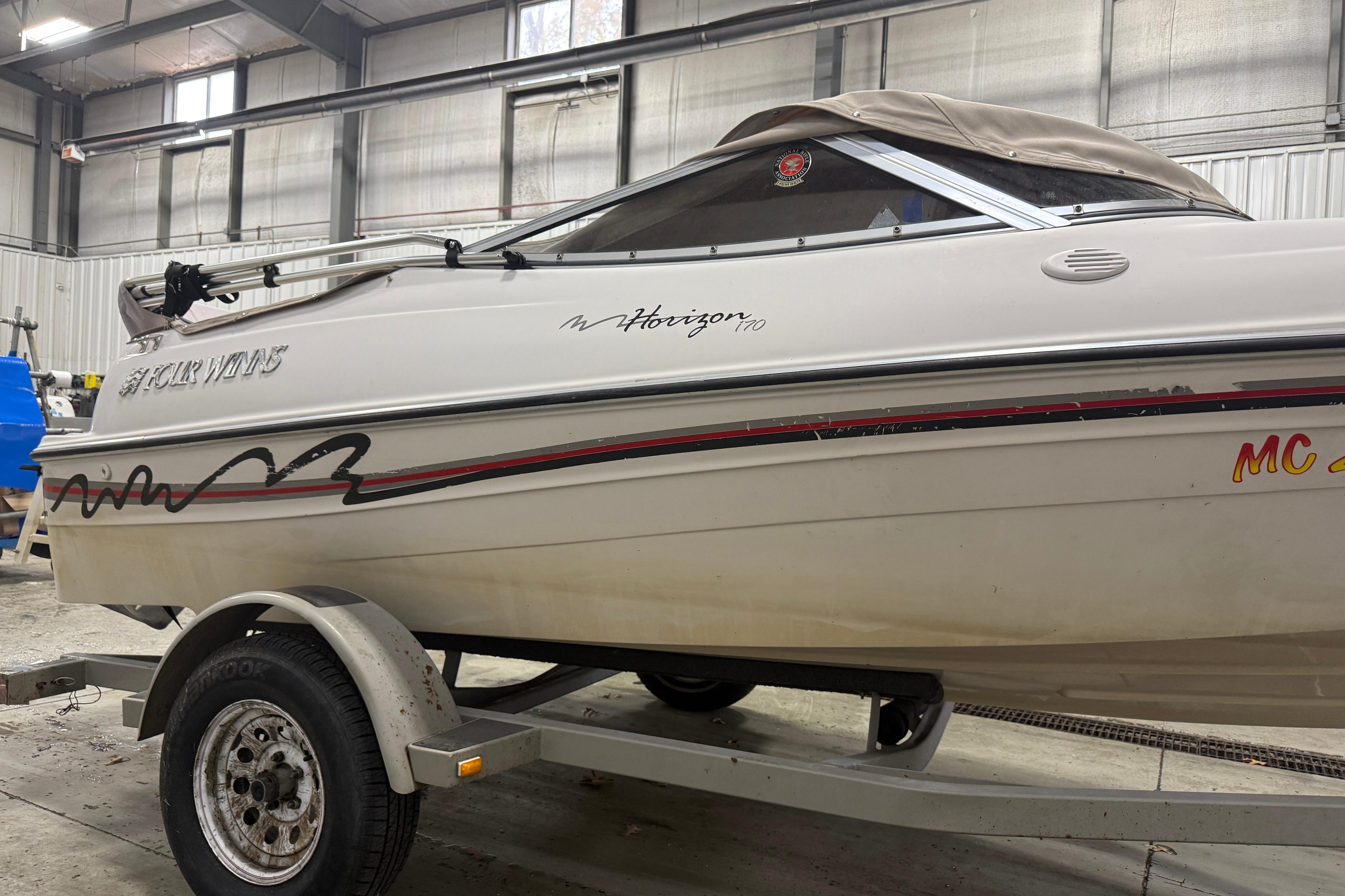 1999 Four Winns 170 Horizon LE boat on trailer in indoor storage.