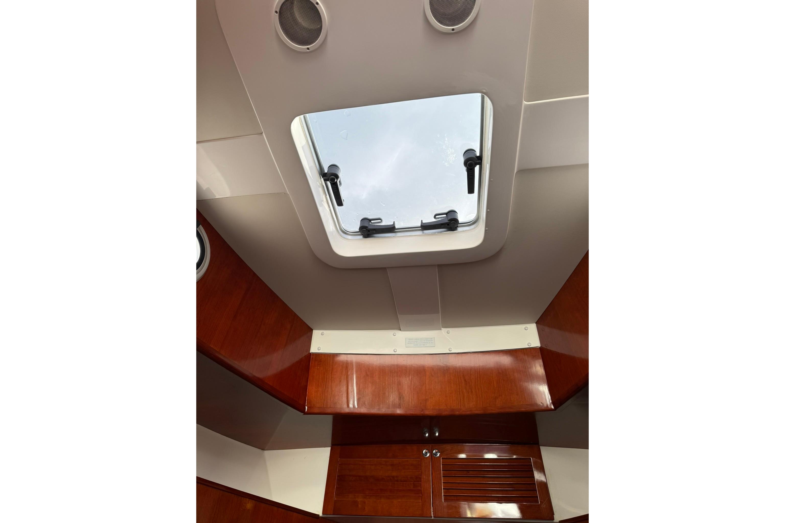 Interior view of 2020 SeaPiper 35 boat, featuring a skylight and wooden cabinetry.
