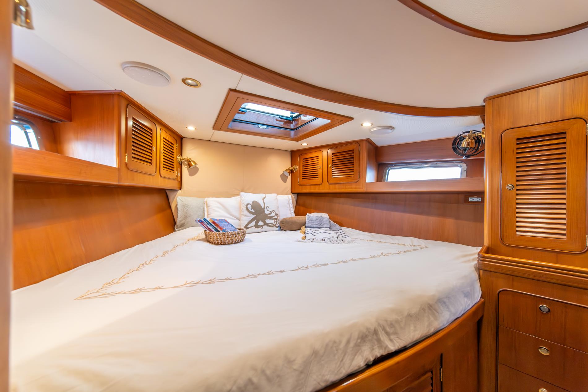 Luxurious cabin interior of 2010 Hylas 70 yacht with wood finish and skylight.