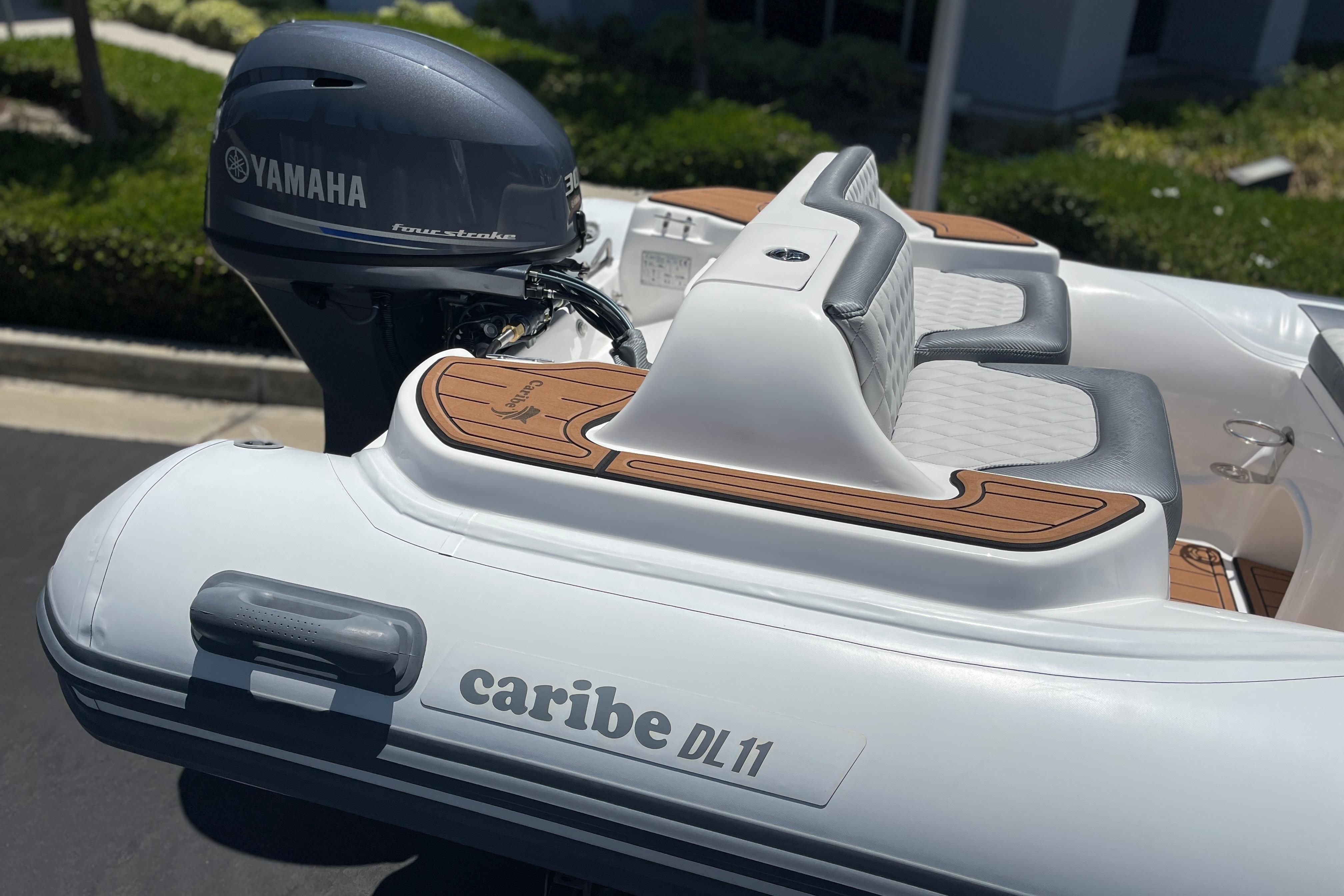 Caribe DL11 boat with Yamaha engine, featuring sleek seating and modern design, 2025 model.