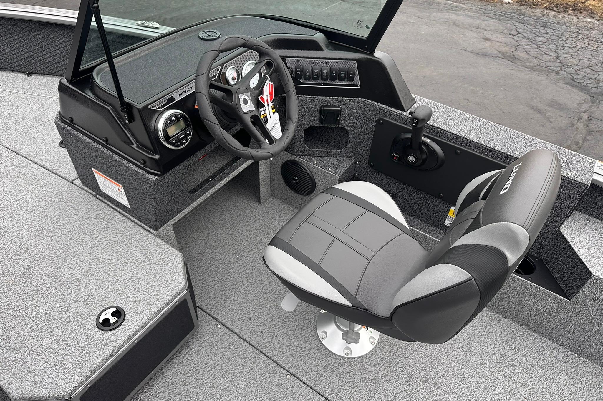 2026 Lund 1775 Impact XS Sport boat interior with steering wheel and captain's chair.