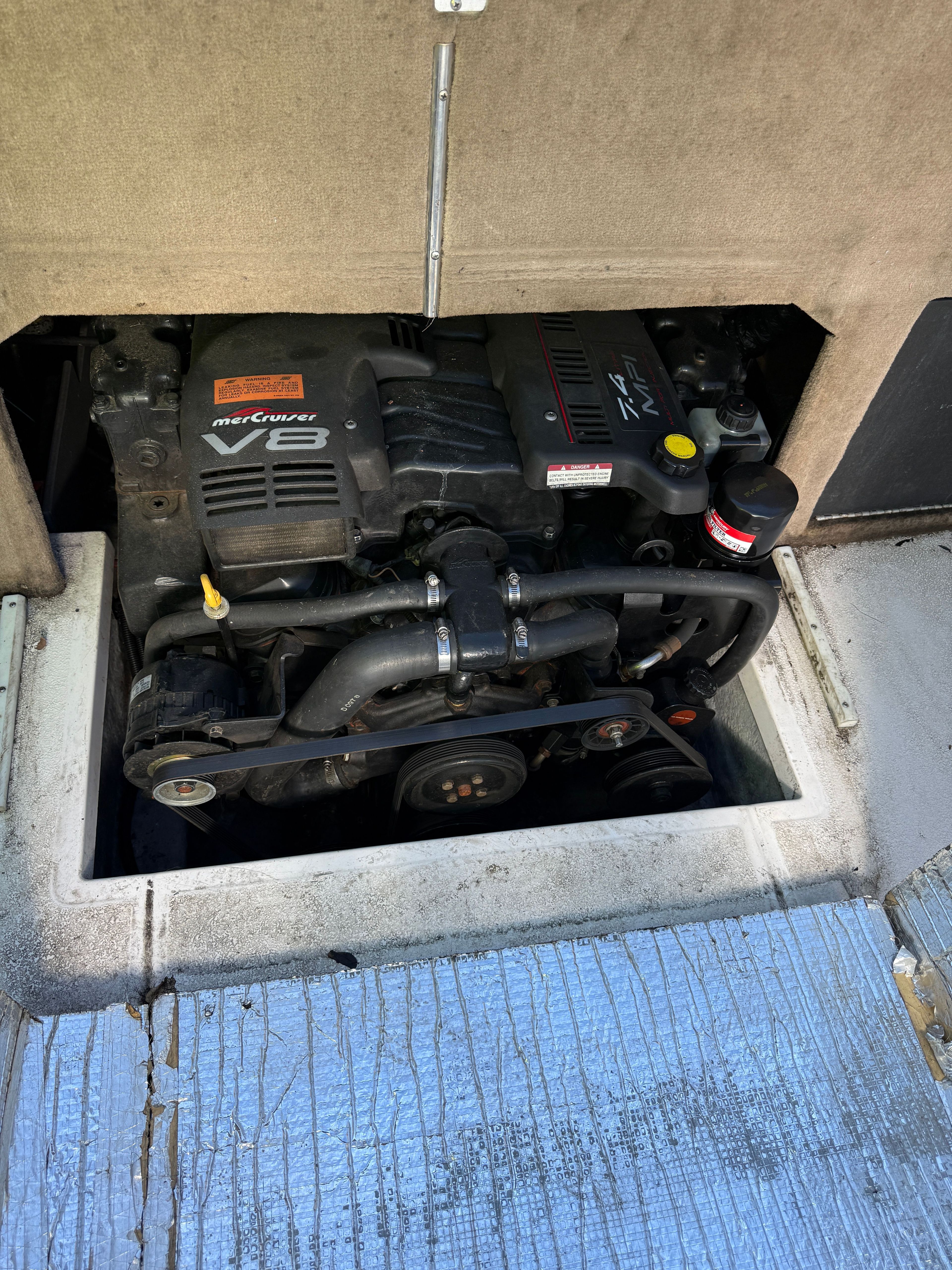 Engine compartment of a 1999 Custom 2335 Cuddy Cabin boat.