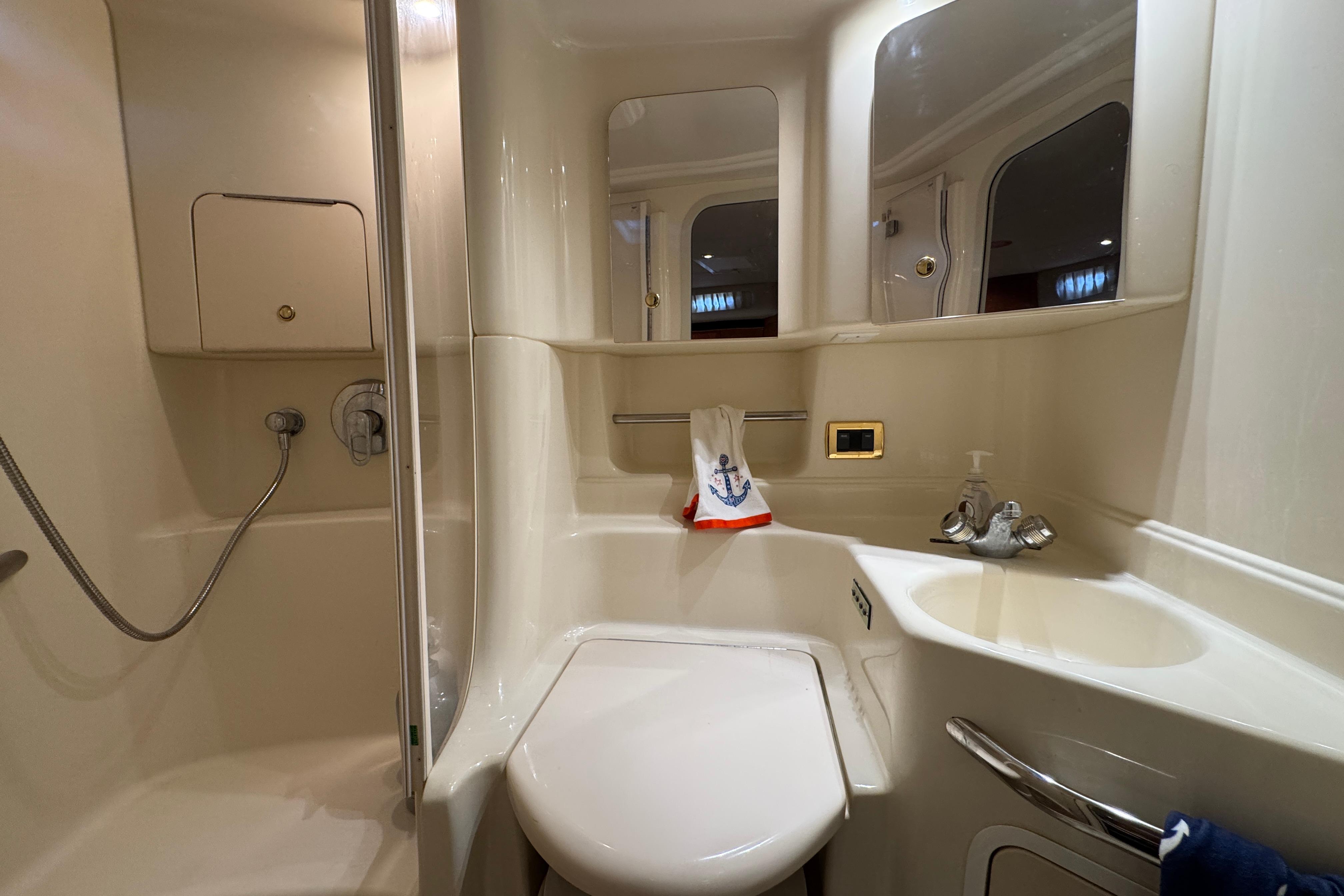 Bathroom interior of 2001 Sea Ray 380 Sundancer yacht, featuring shower and sink.