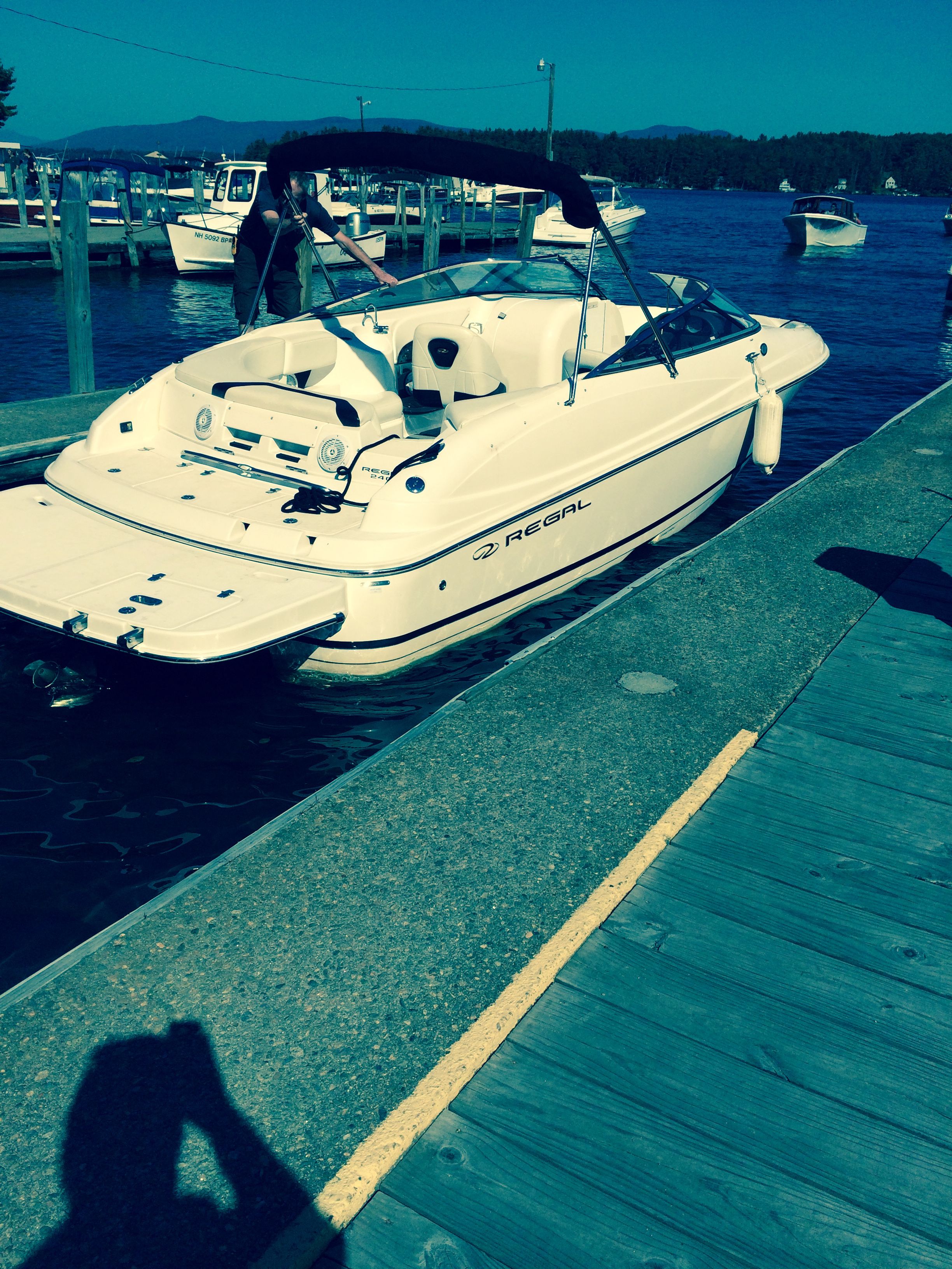 2007 Regal 2400 Bowrider boat docked at a marina on a sunny day.