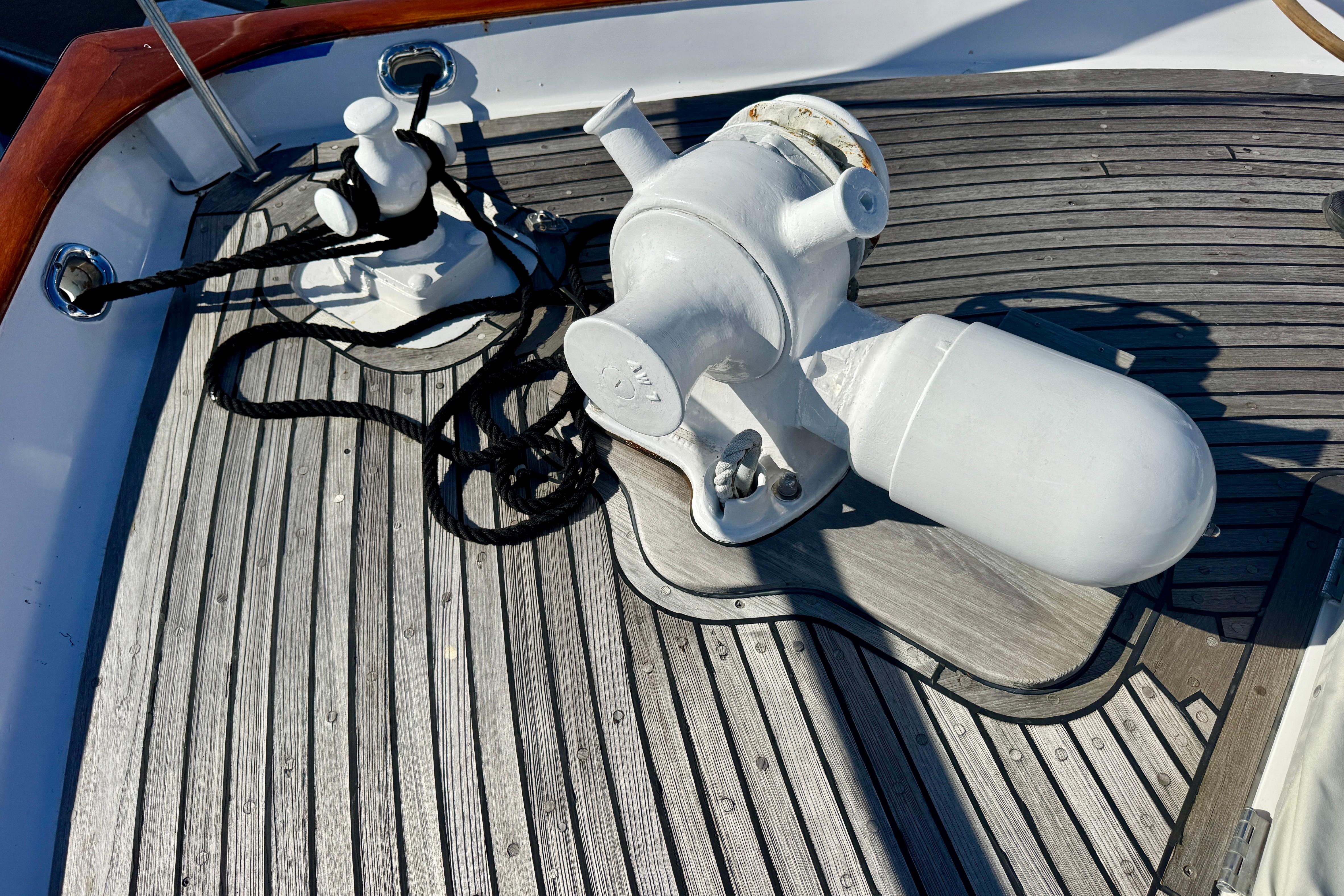 1958 Blanchard Pilothouse deck with winch and cleat on wooden surface.