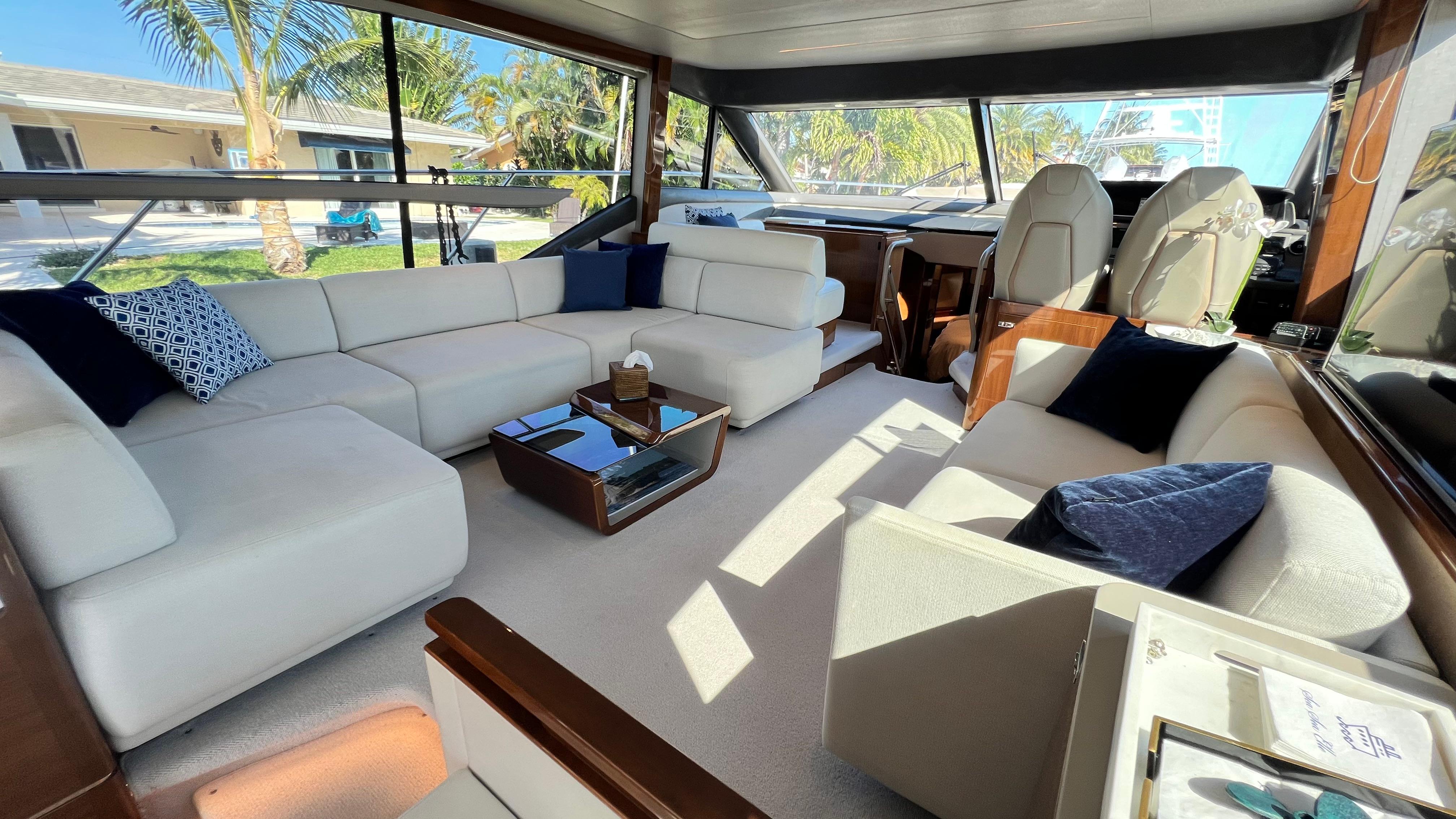 Luxurious interior of 2019 Princess F62 yacht with elegant seating and panoramic windows.