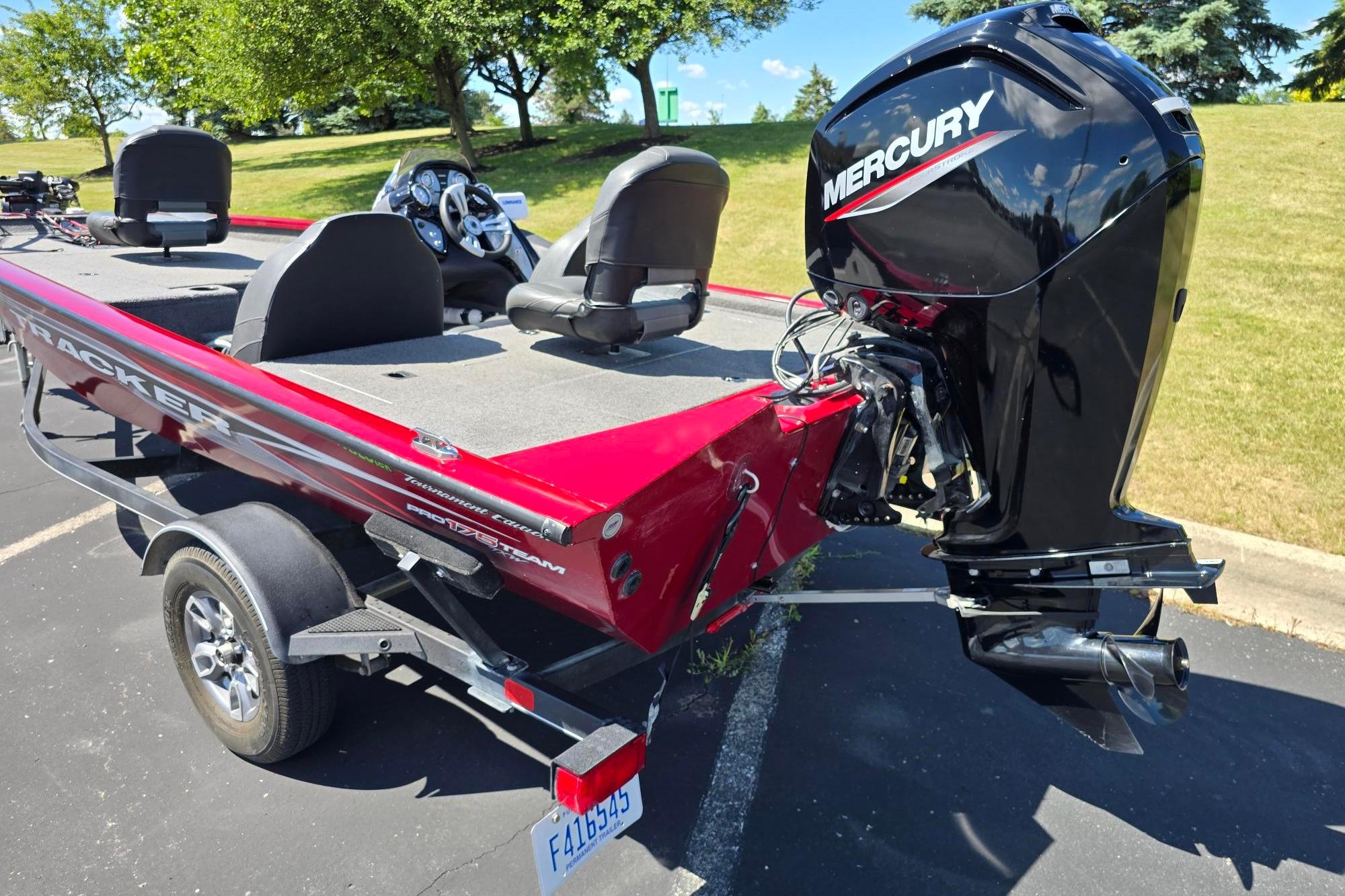 2021 Tracker Pro Team 175 TXW boat with Mercury engine, parked outdoors on a sunny day.