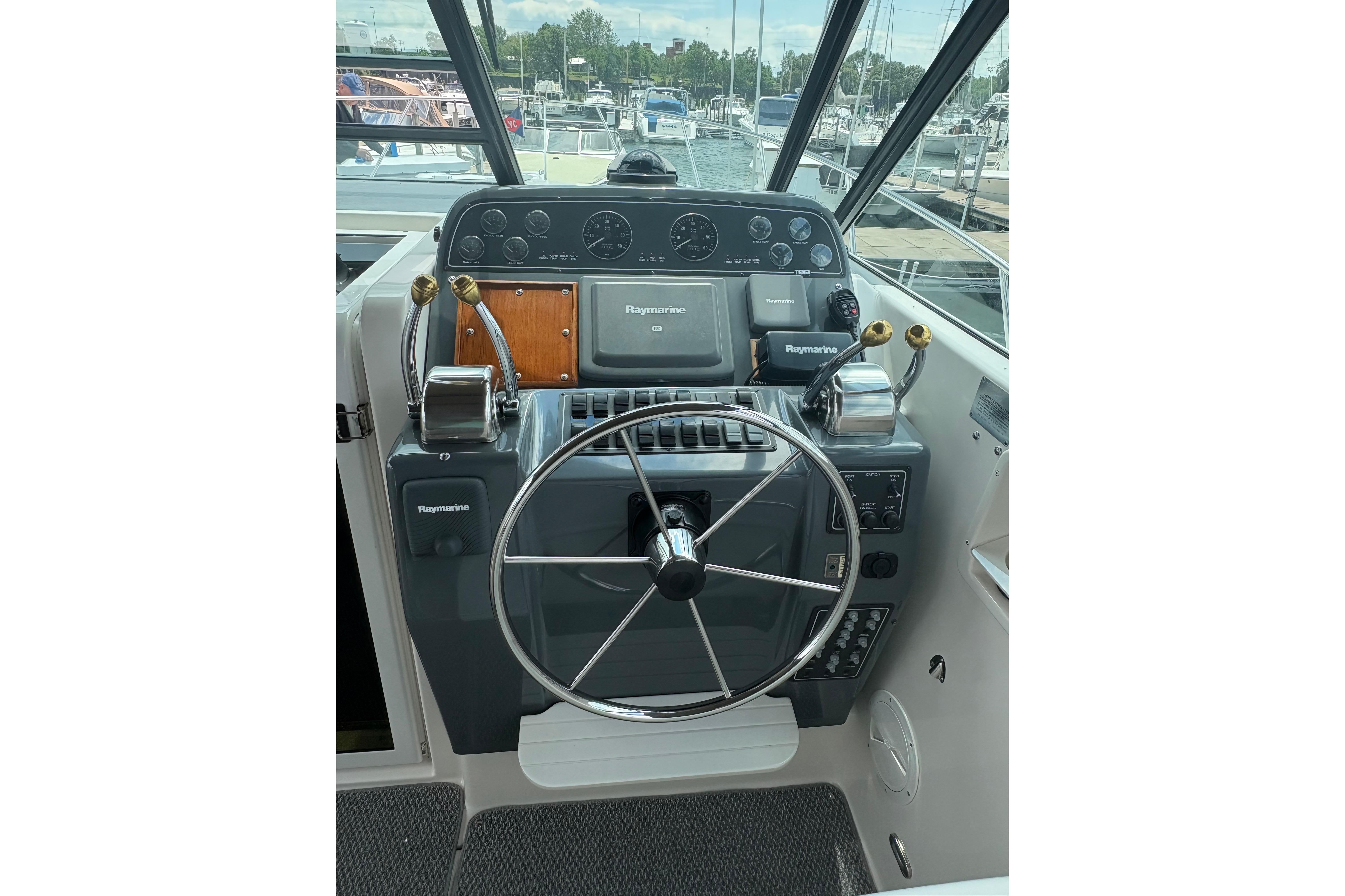 1999 Tiara Yachts 3100 Open helm with Raymarine electronics and dual throttle controls.