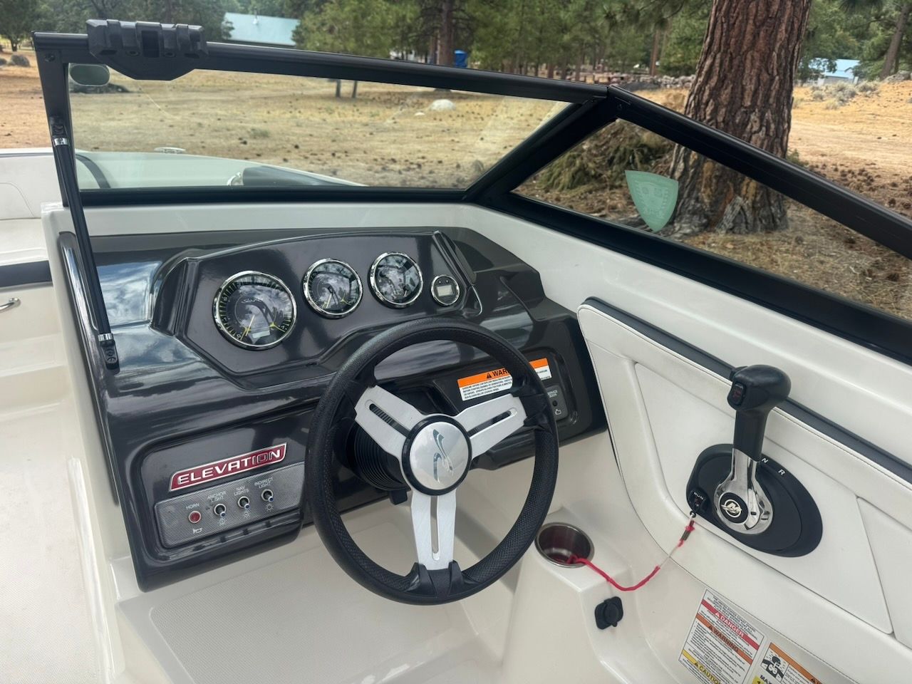 The image shows the cockpit of a 2016 Sea Ray SPX 190 Outboard with a modern dashboard.